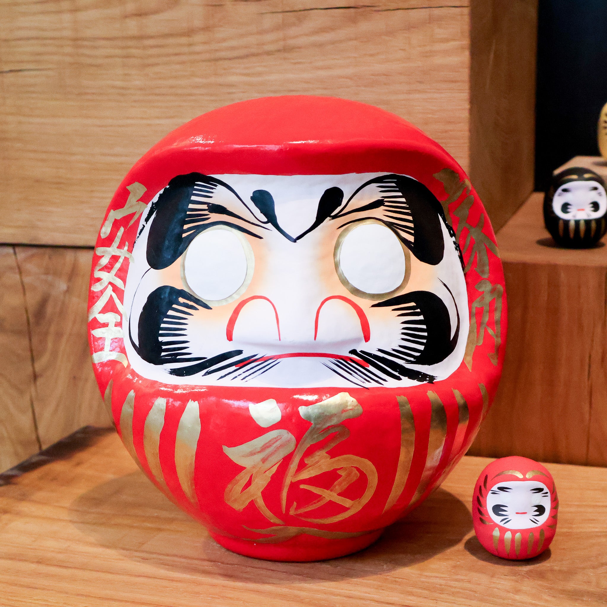 Daruma figure between