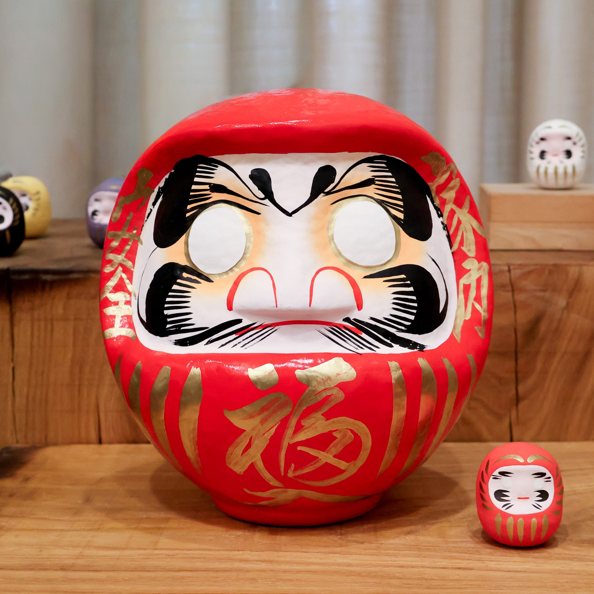 Daruma figure between