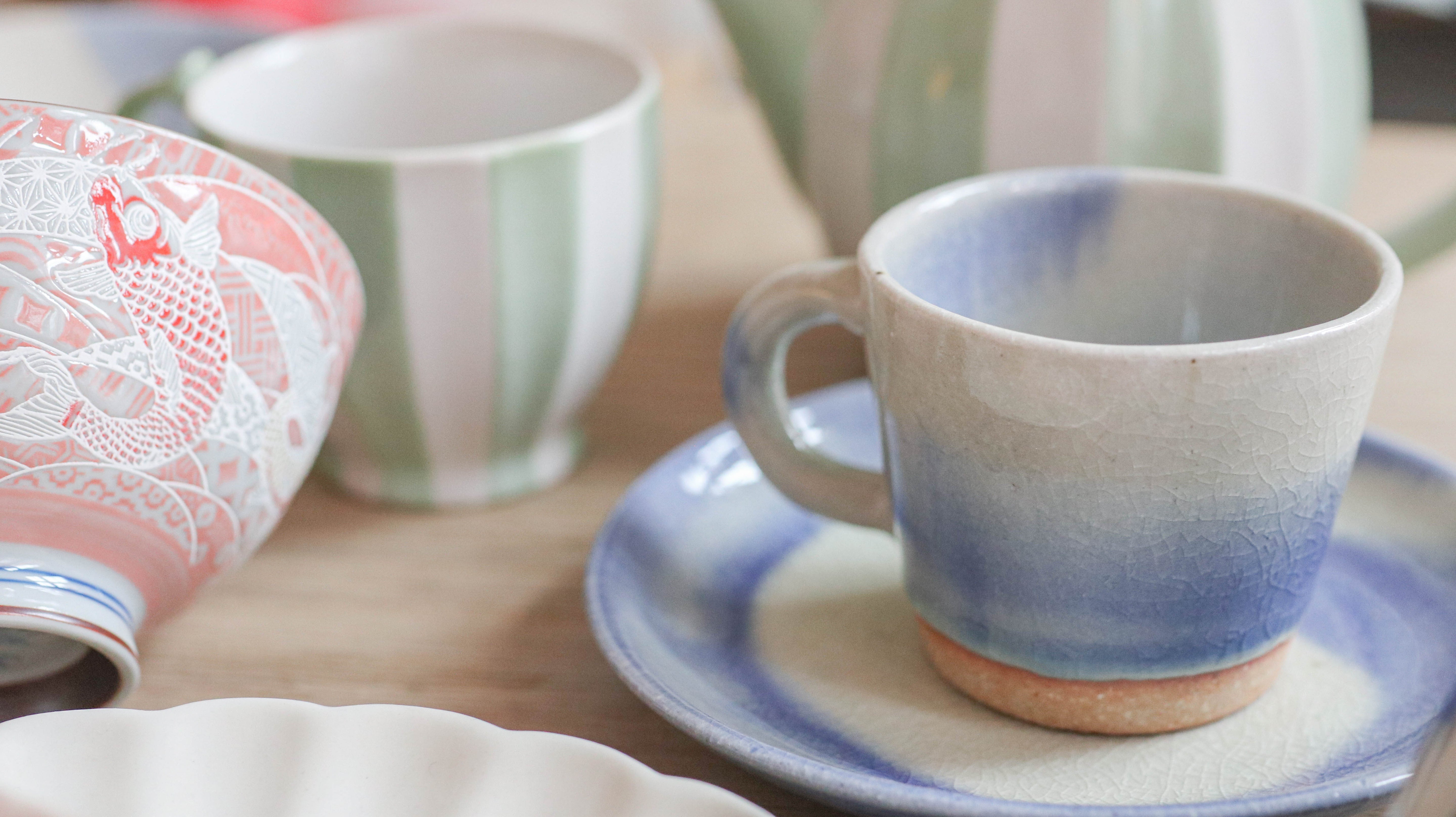 Ceramic cup and saucer with cracked blue glaze