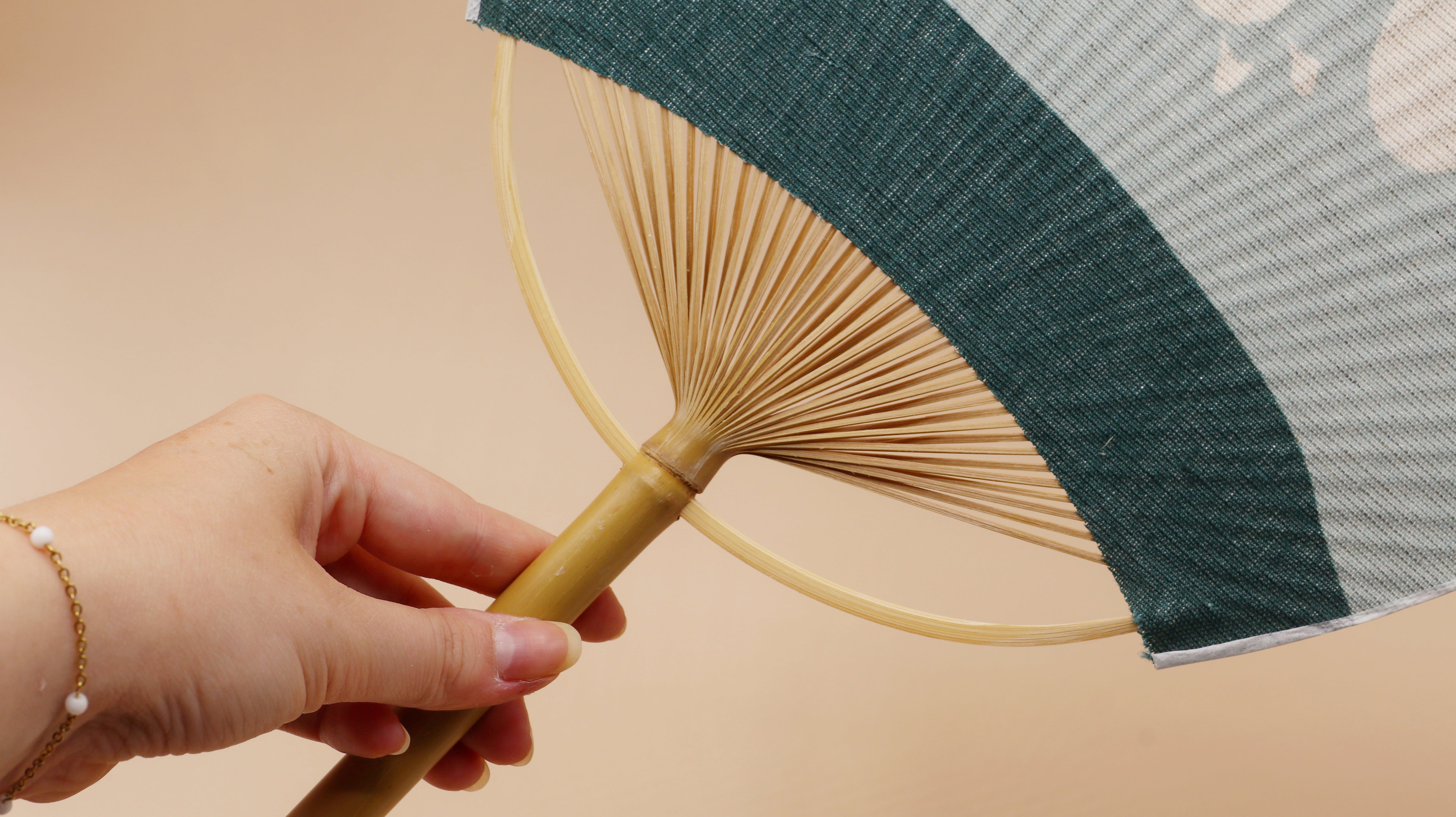 Bamboo fan in blue with white birds