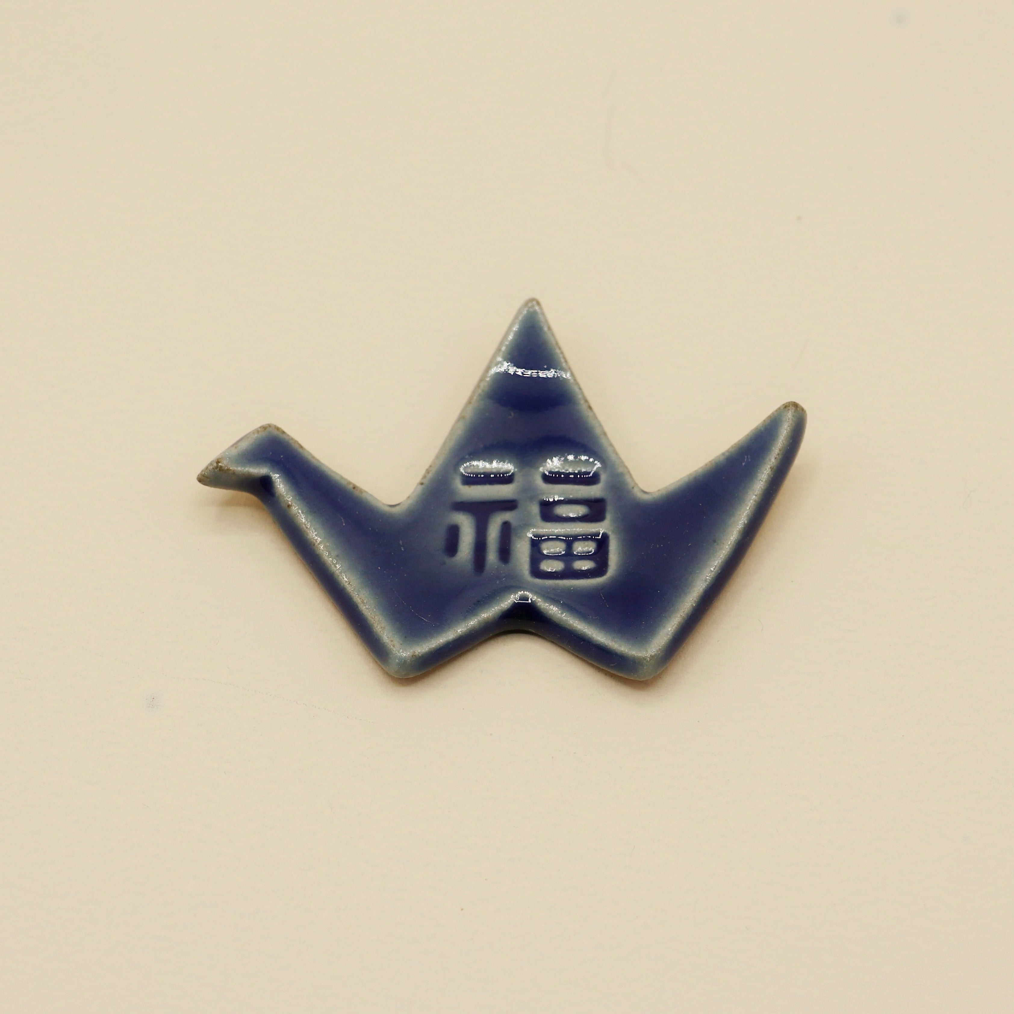 Spisepindeholder - Blå origami fugl med tegn