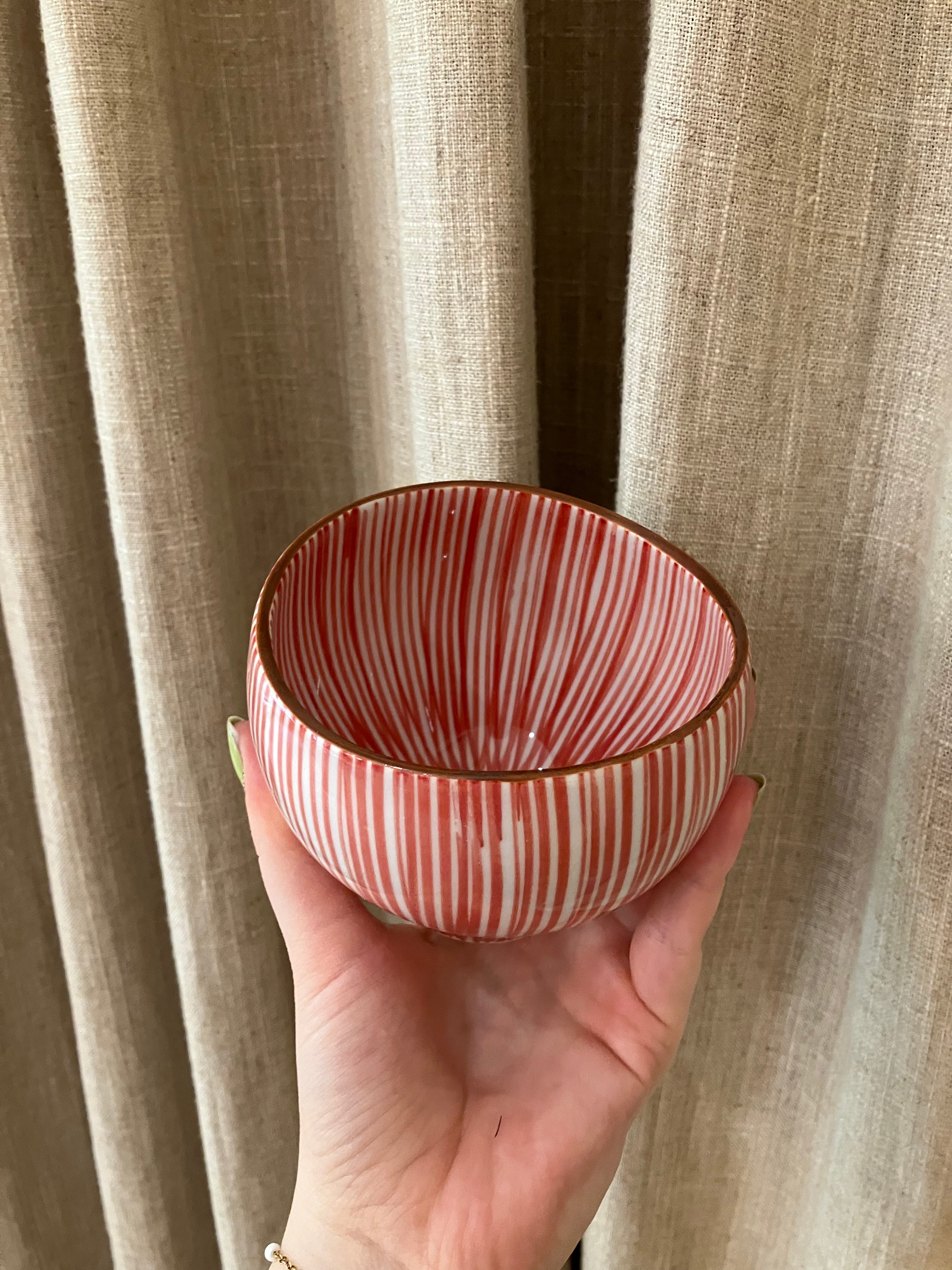 Cup with red vertical stripes and brown rim