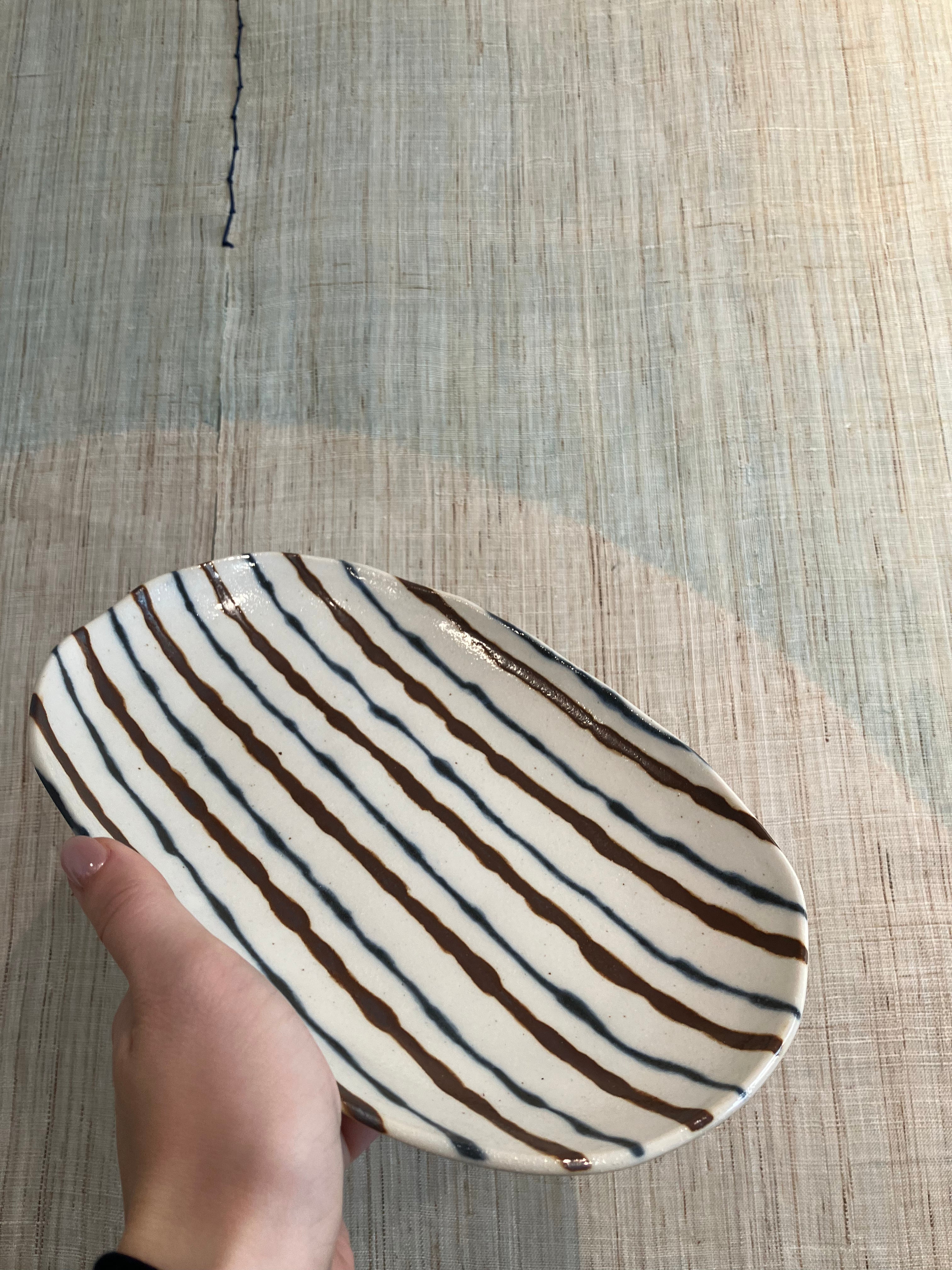 Oval dish with brown and blue stripes