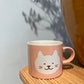 Lyserød kop med hvid kat