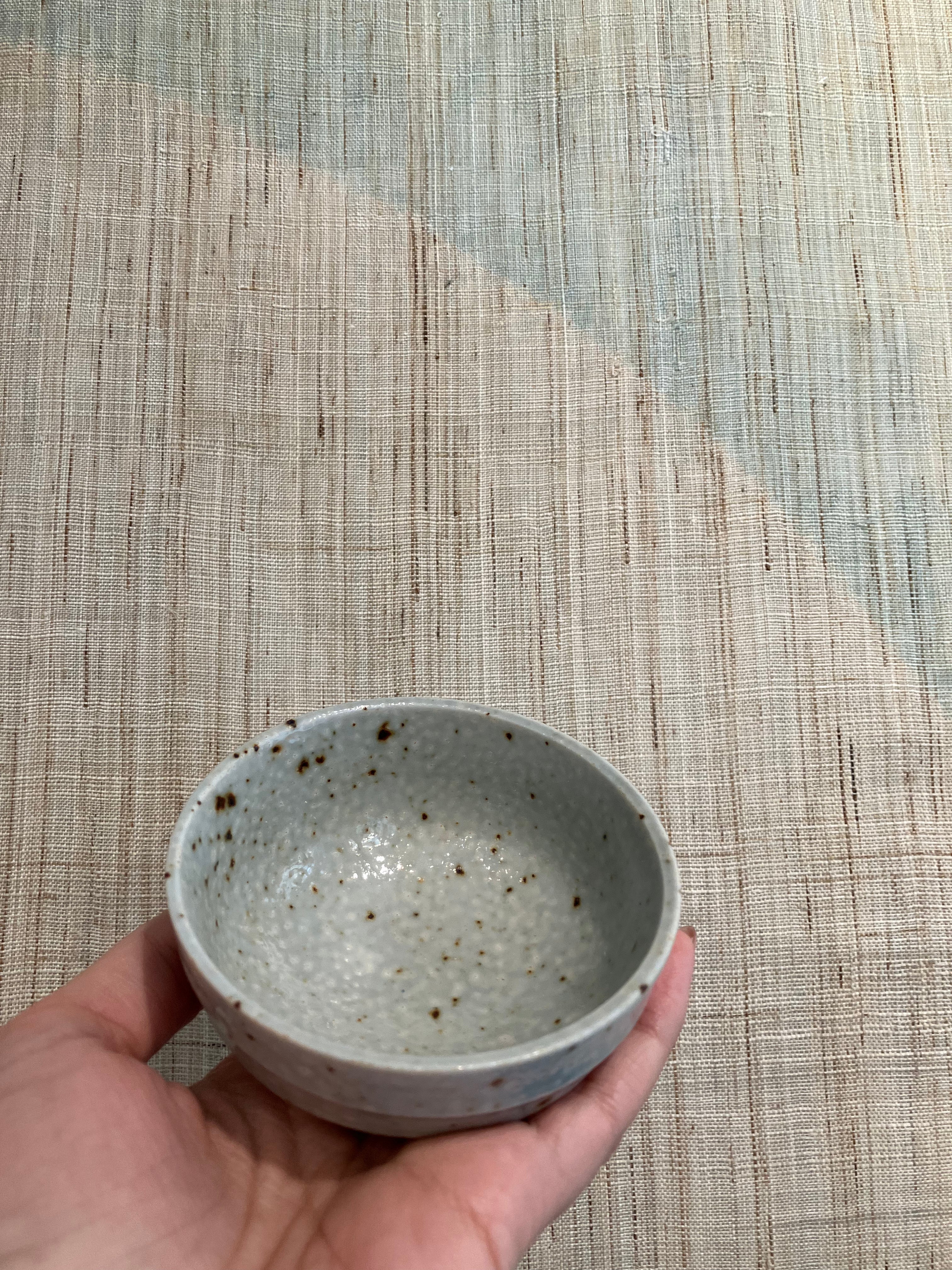 Small bowl with blue-grey glaze and brown dots