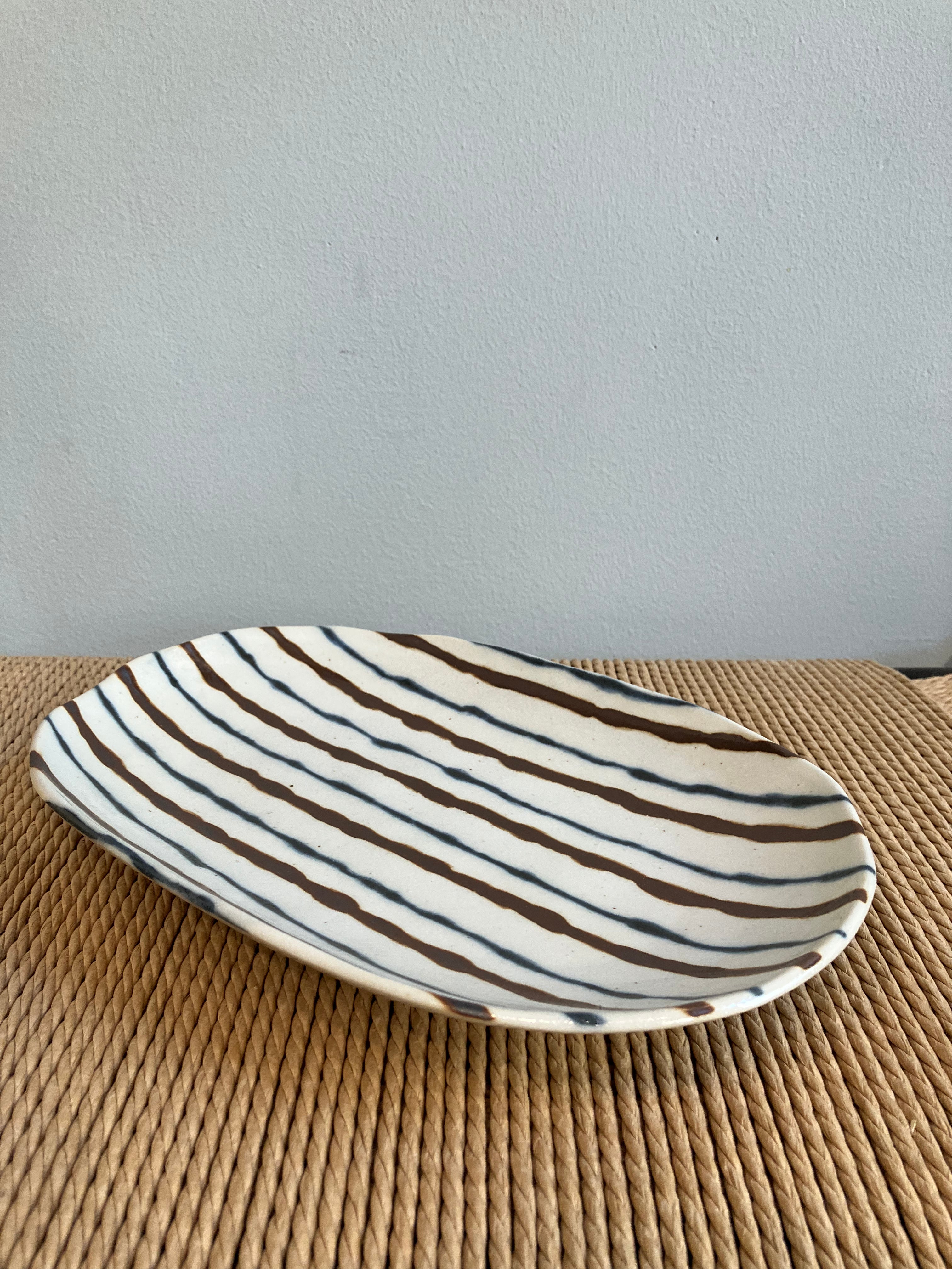 Oval dish with brown and blue stripes