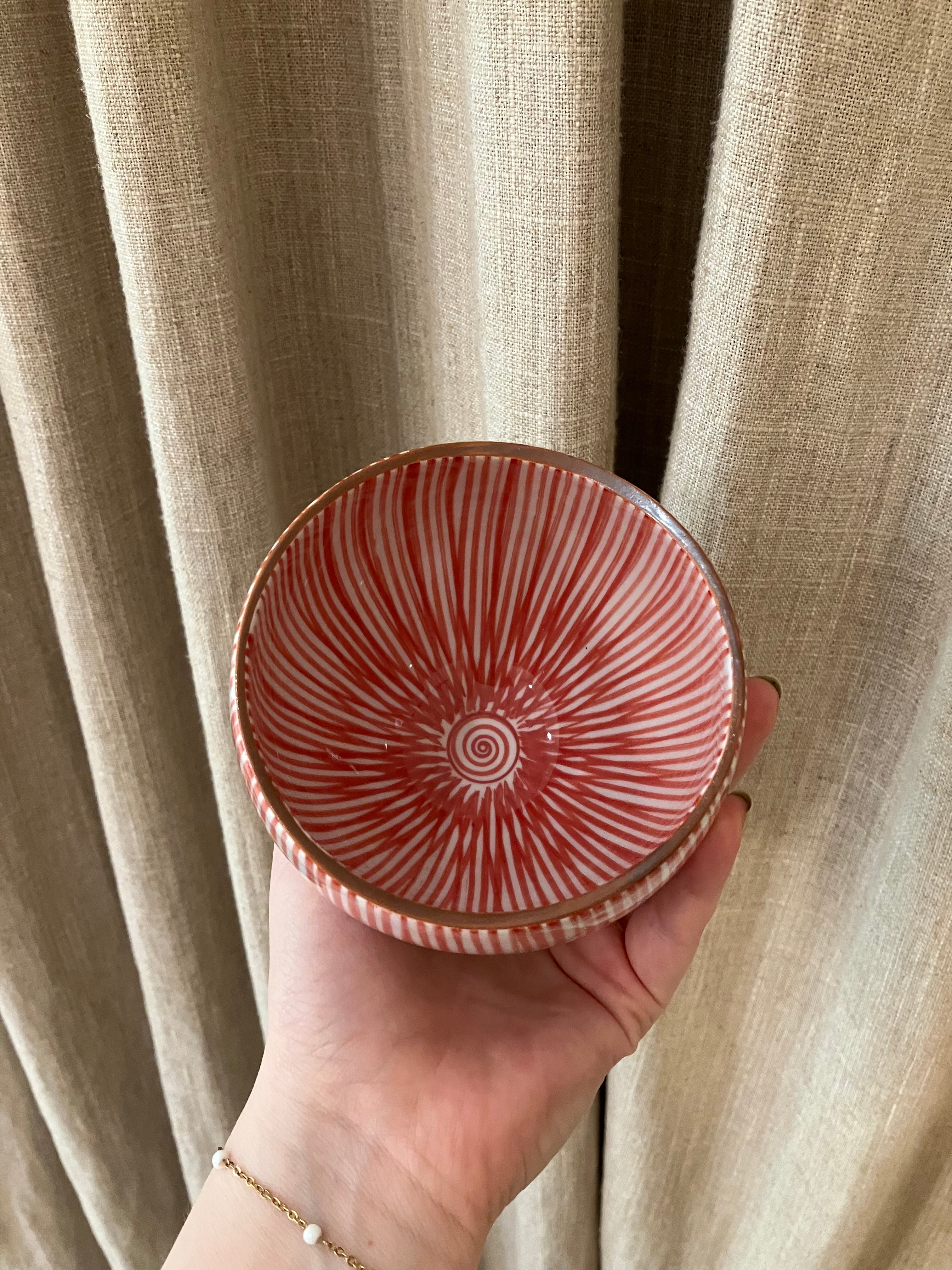 Cup with red vertical stripes and brown rim