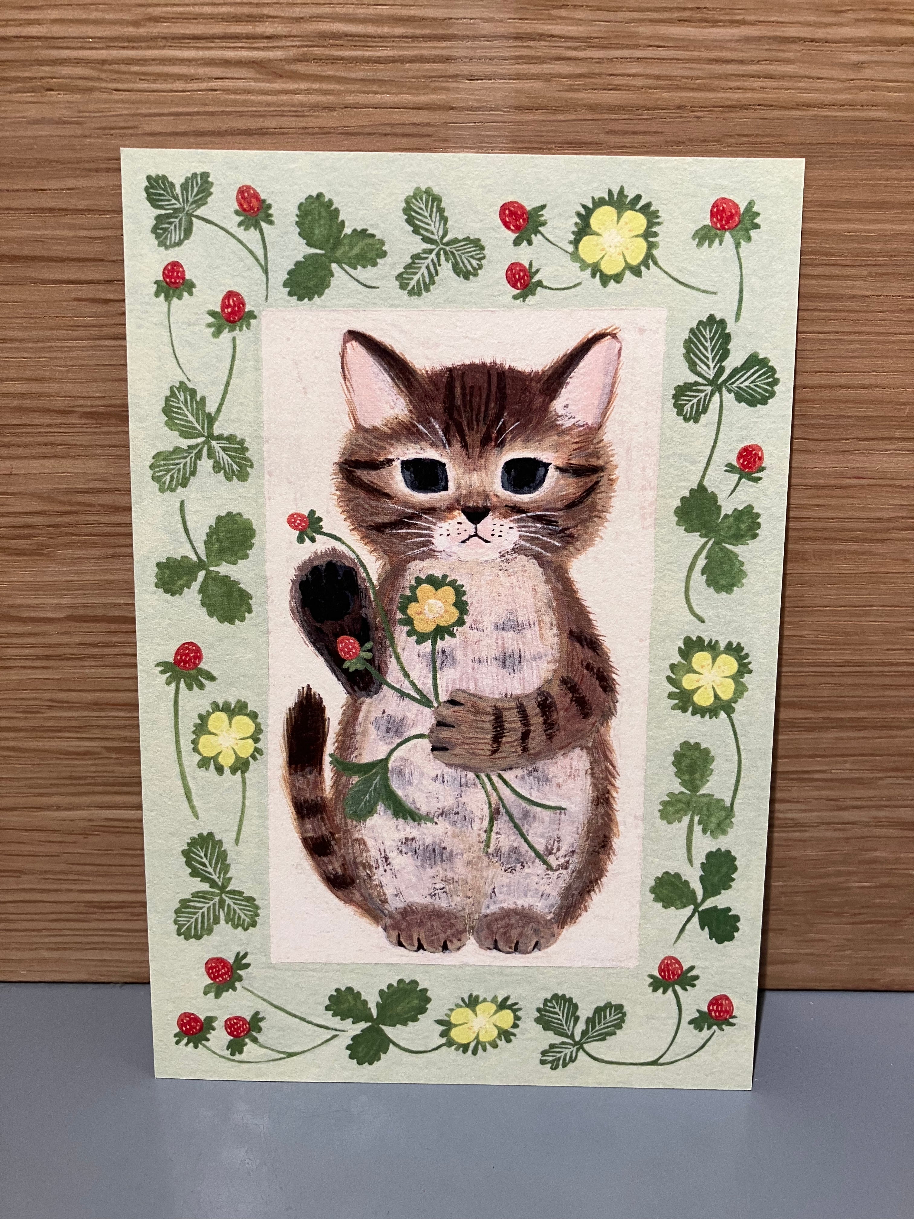 Japanese card green background, with a motif of a cat holding wild strawberries