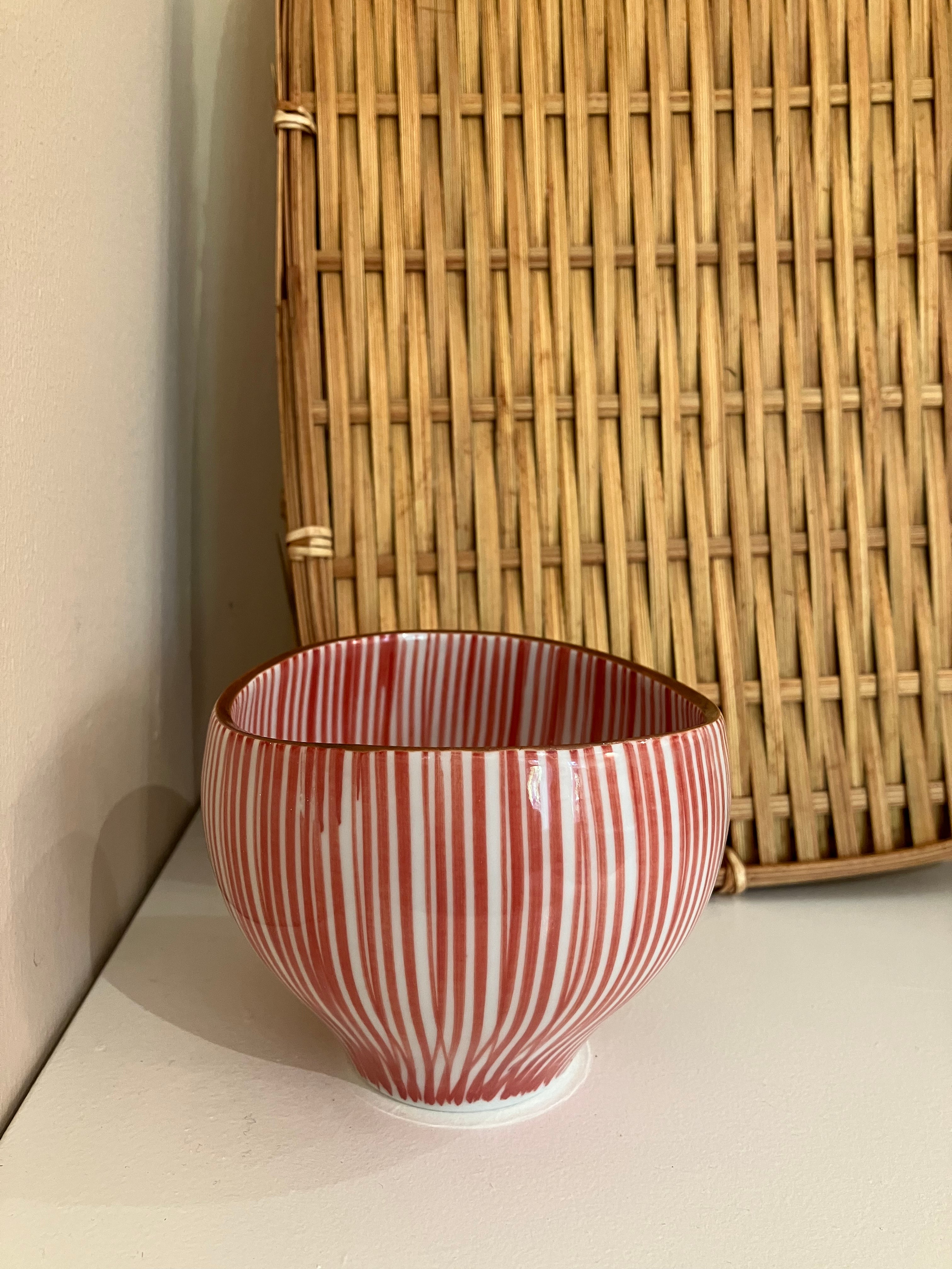 Cup with red vertical stripes and brown rim