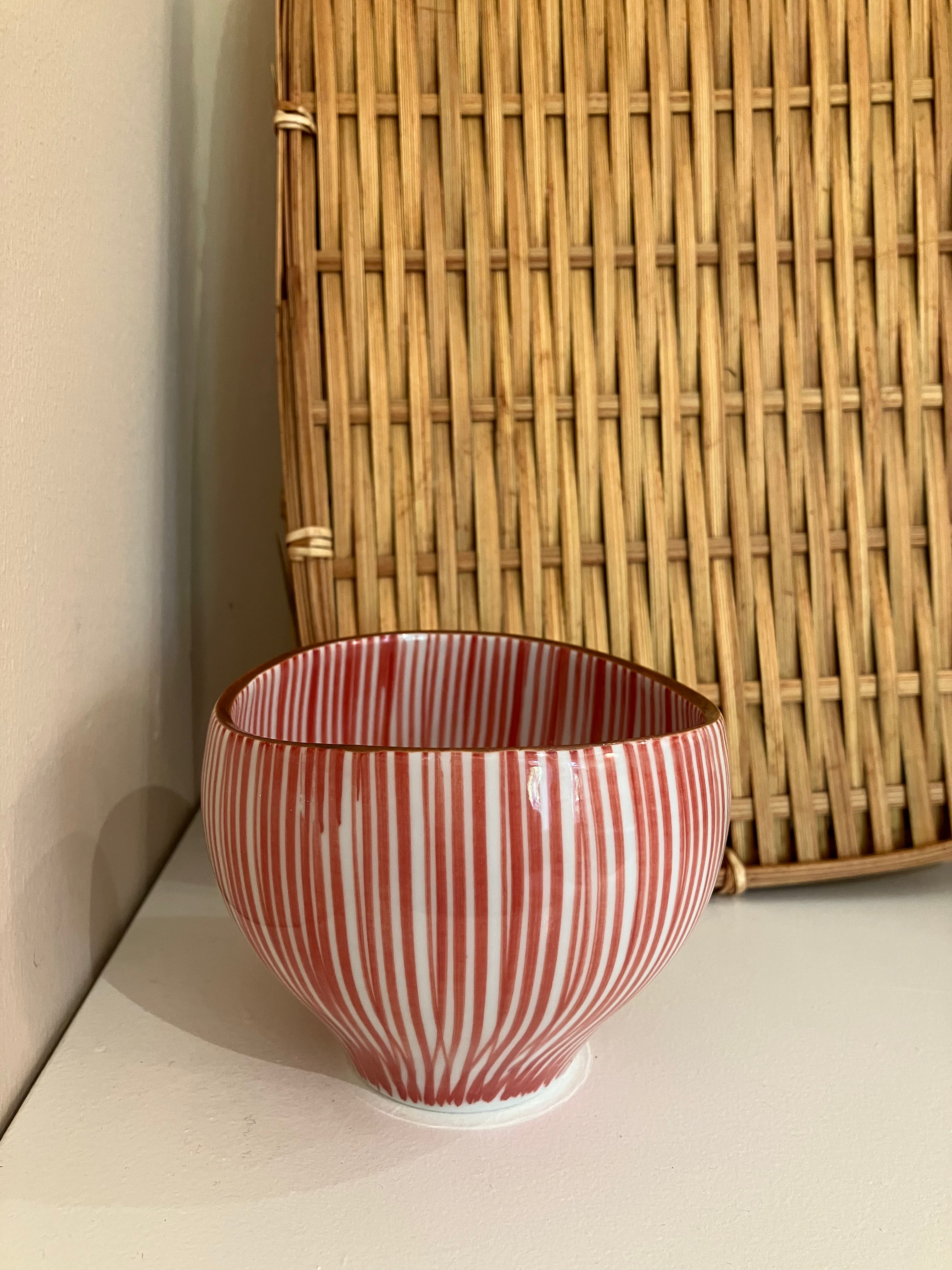 Cup with red vertical stripes and brown rim