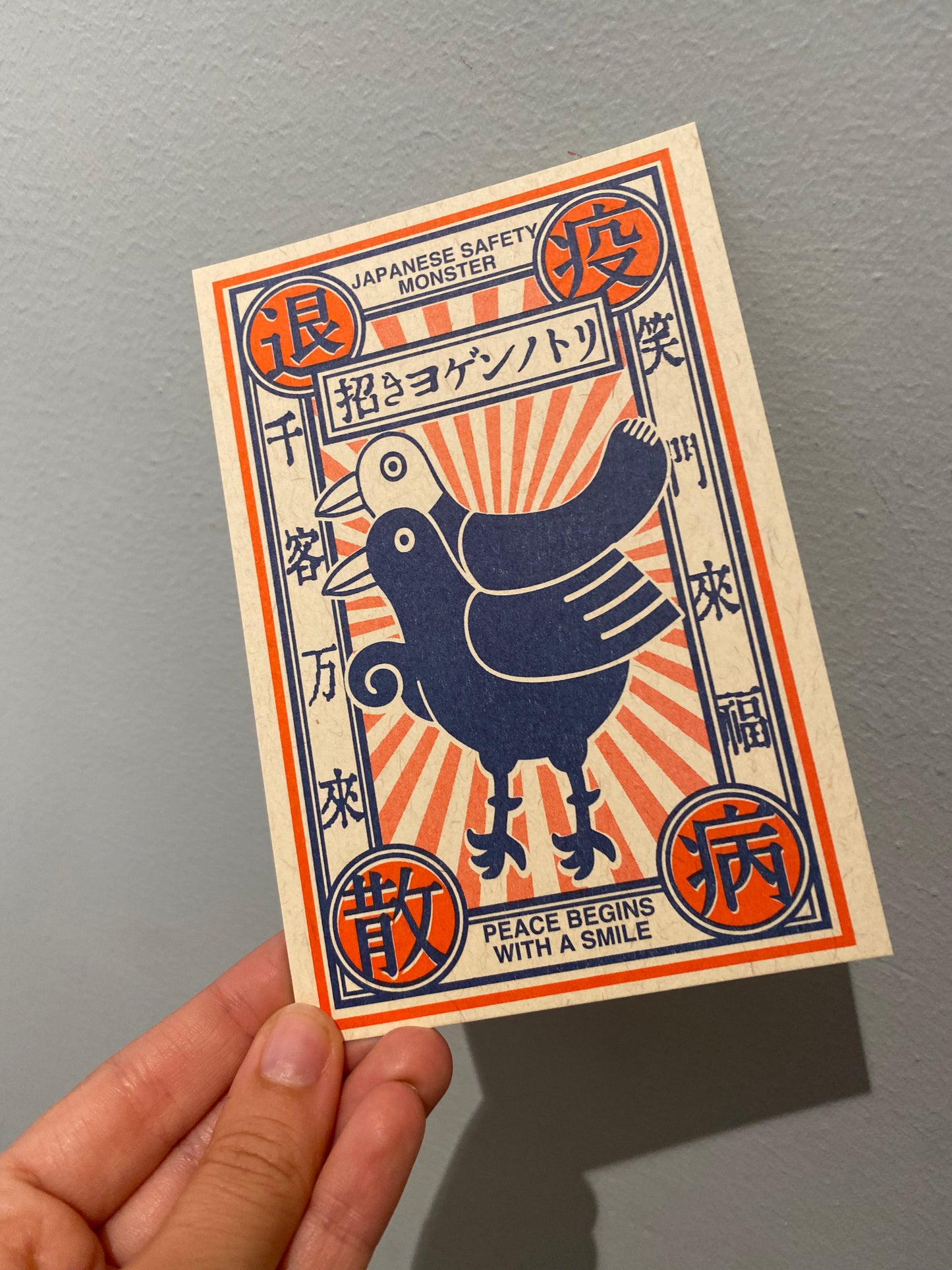 Postkort med japansk ‘safety monster’ og citater