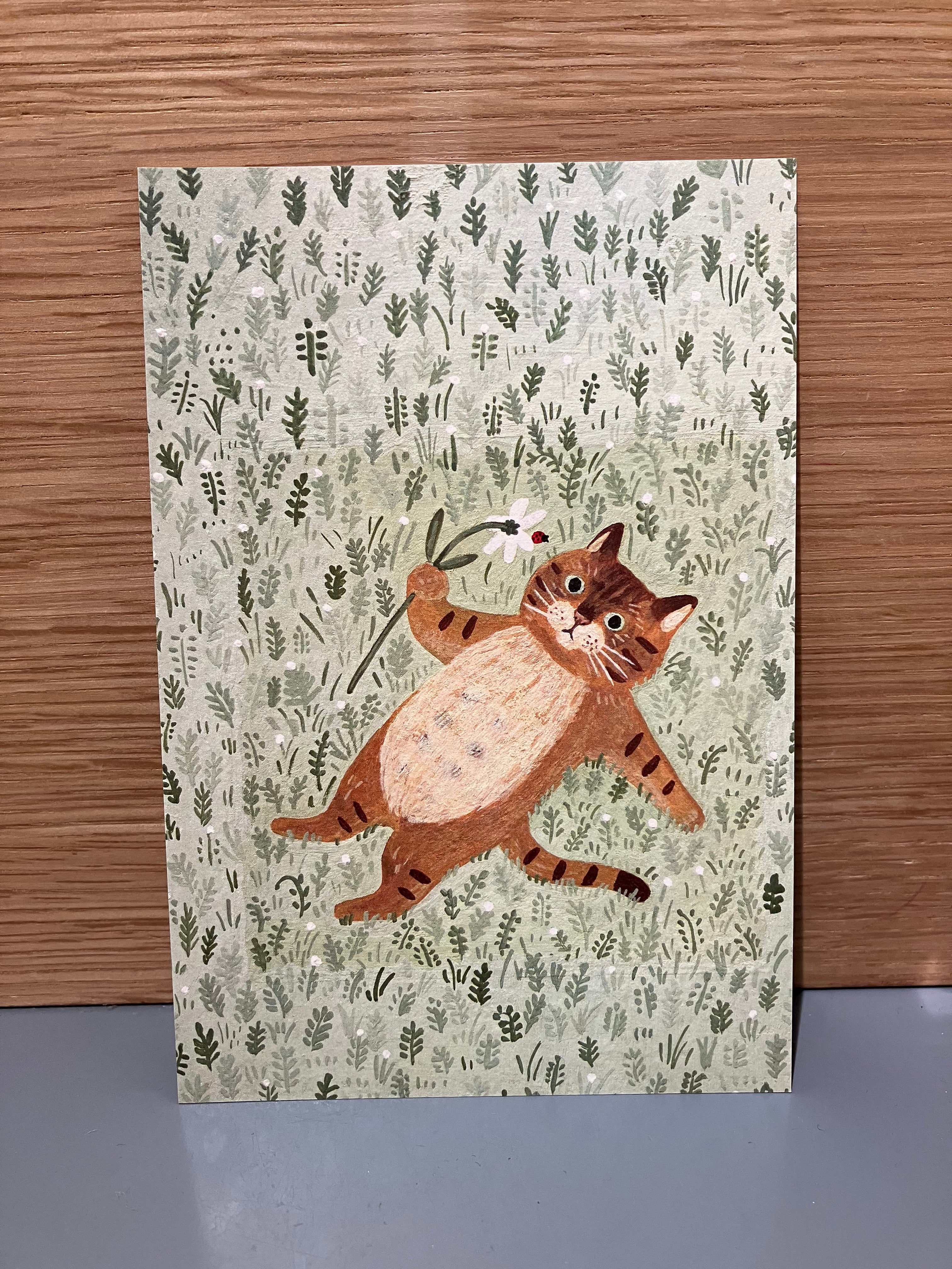 Japanese card with cat lying in the grass