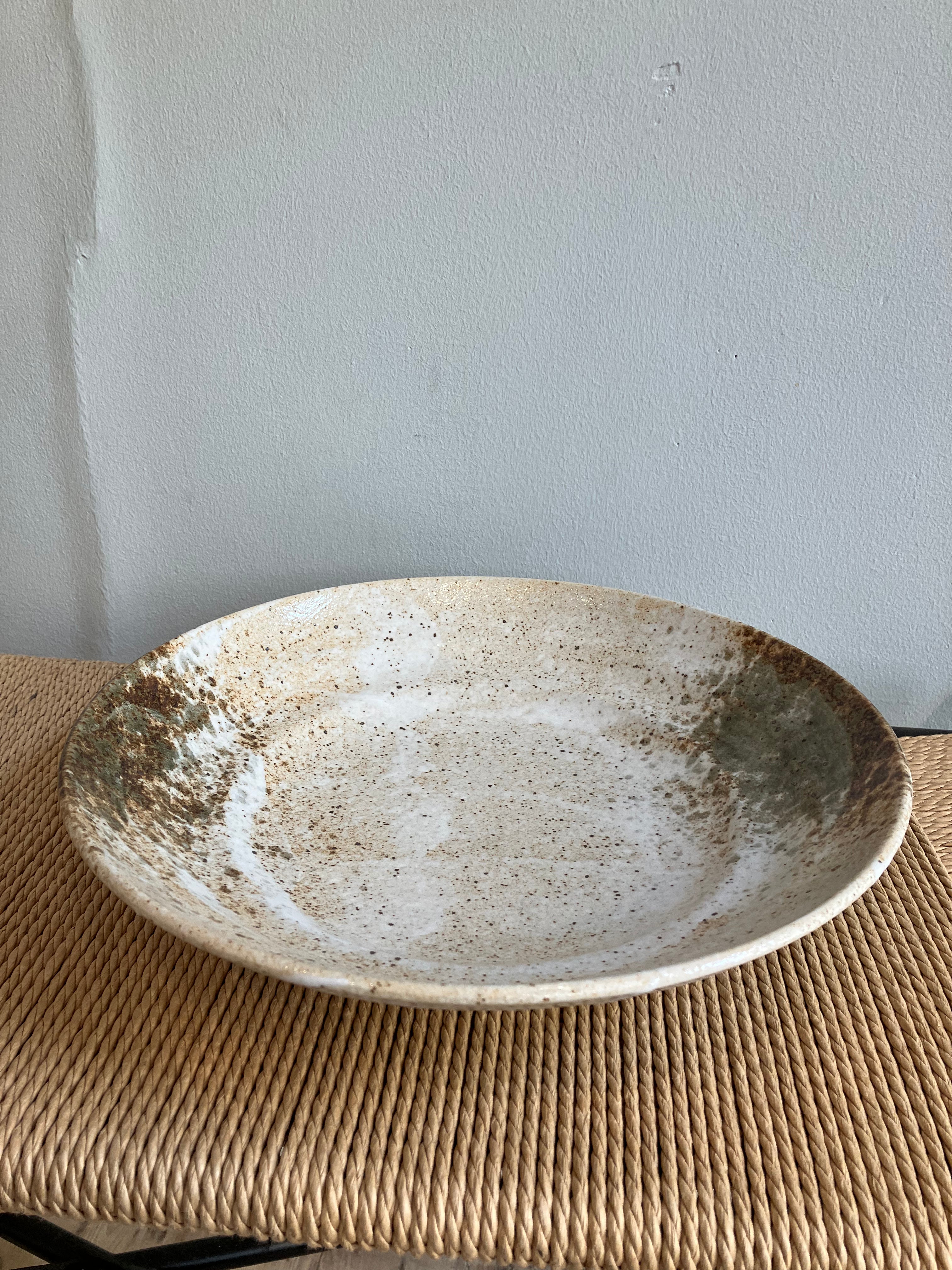 Large dish with rustic glaze in shades of brown and green