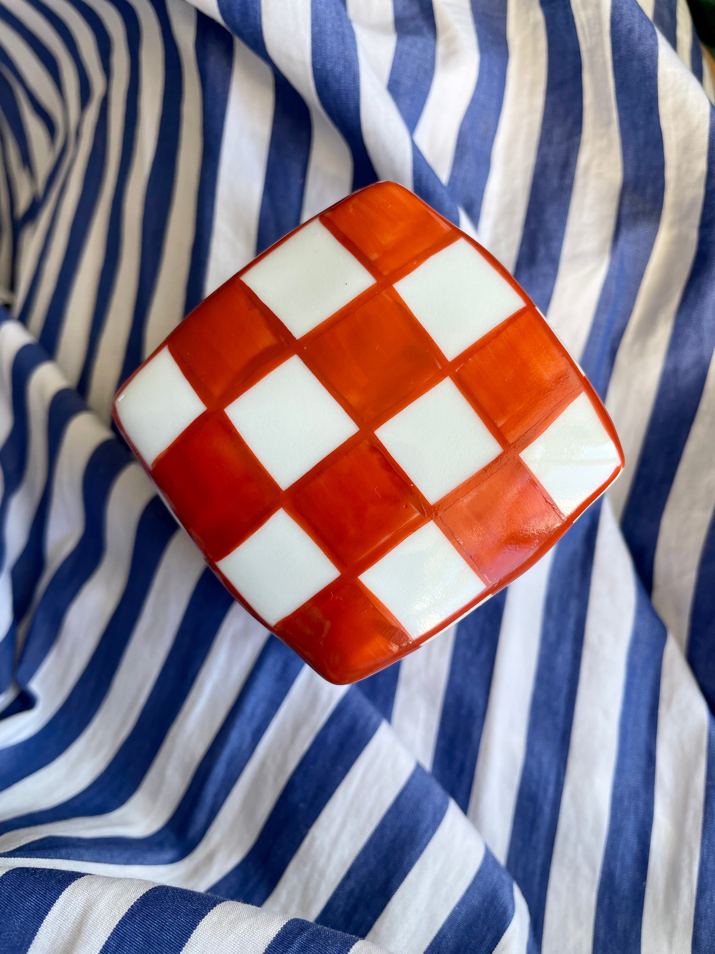 Handmade lidded jar with red/white checkered glaze