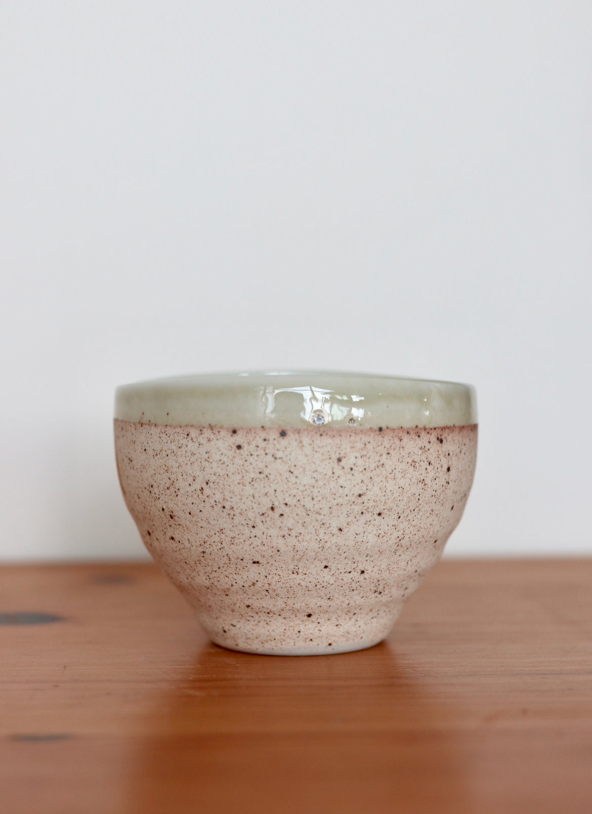 Small ceramic bowl with light green rim