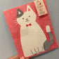 Brevpapir kat på lyserød baggrund med kuvert