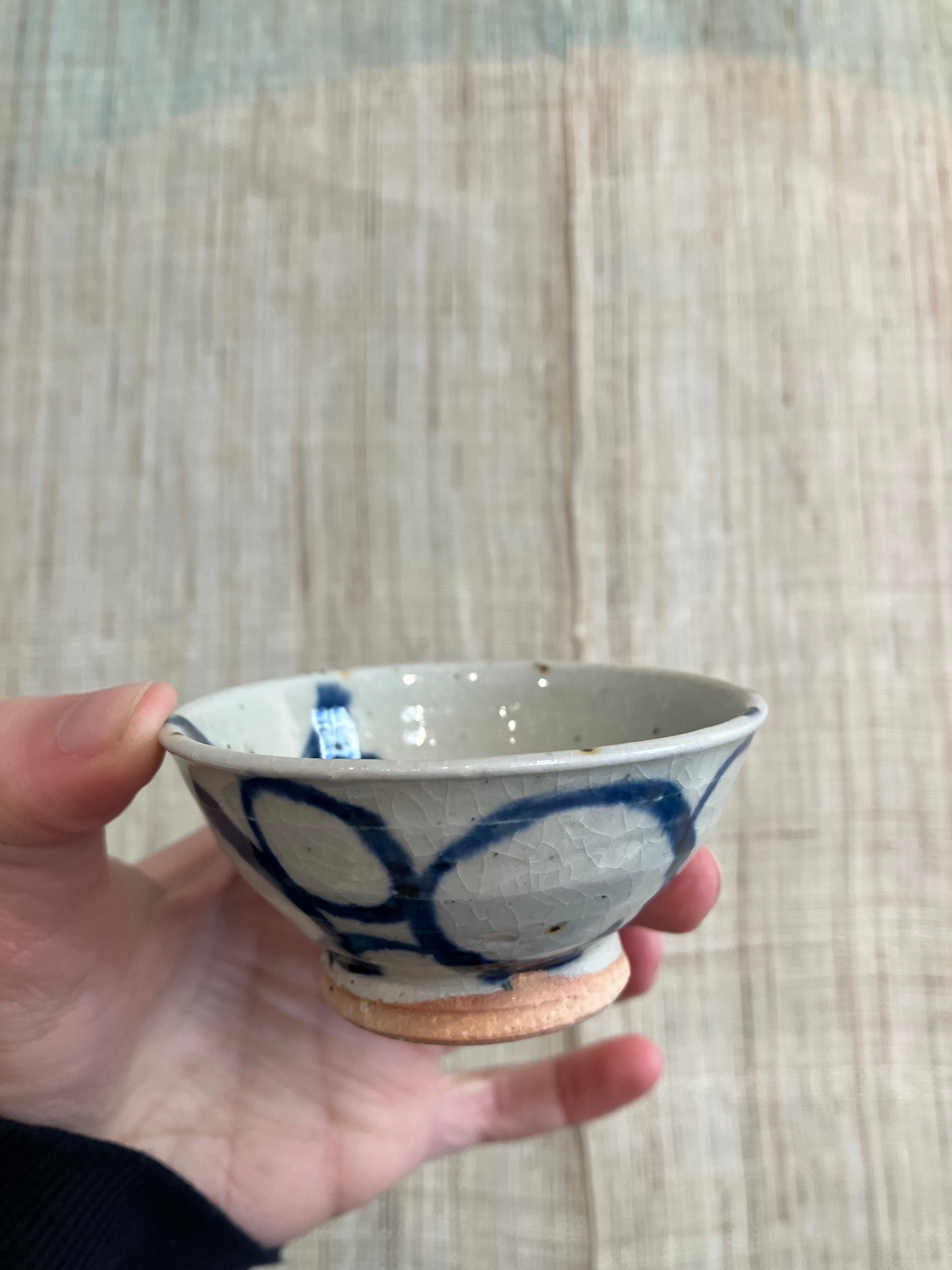 Sake cup sand colored glaze and blue spiral pattern