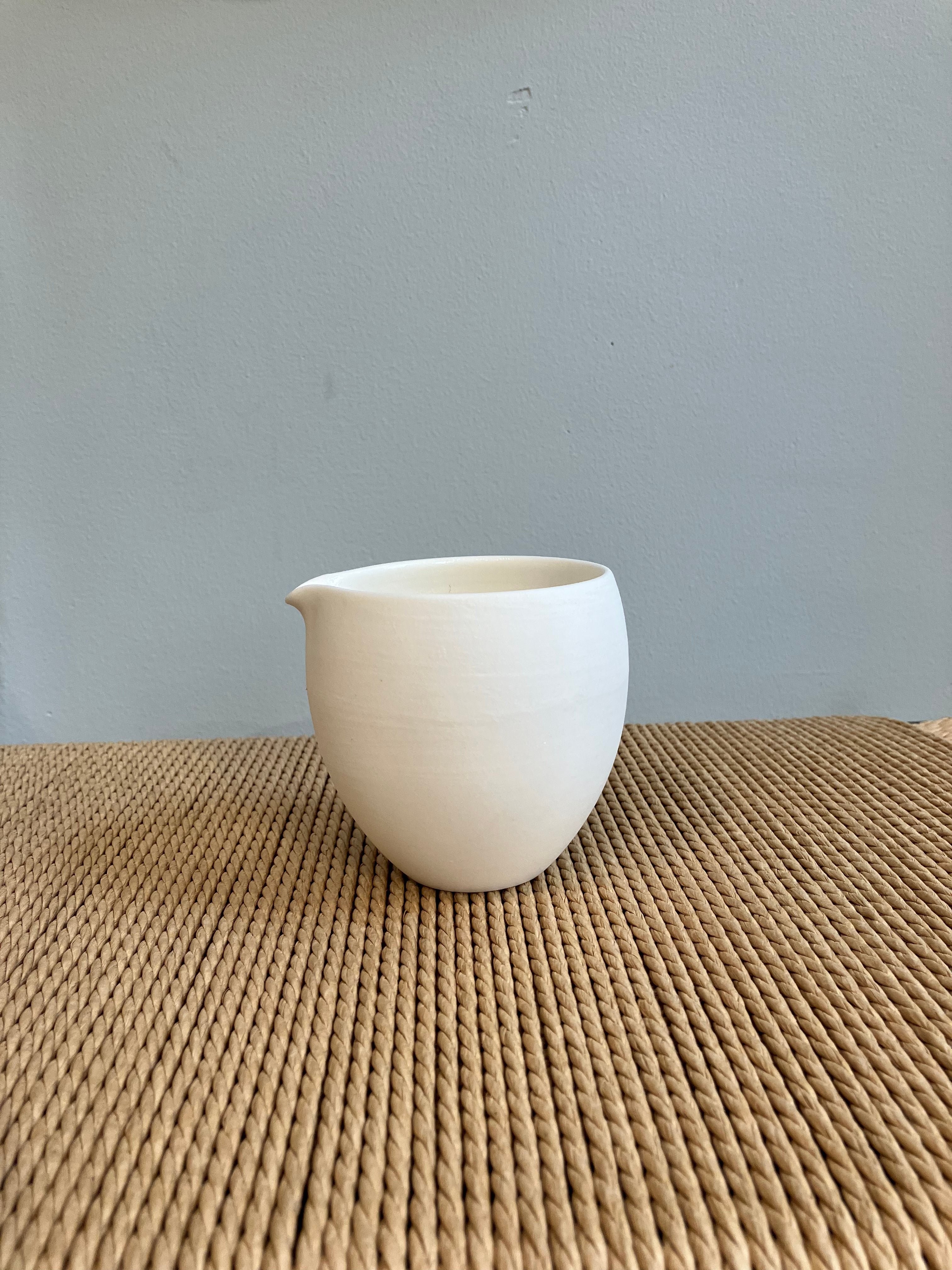 Handmade, white ceramic jug in matt glaze