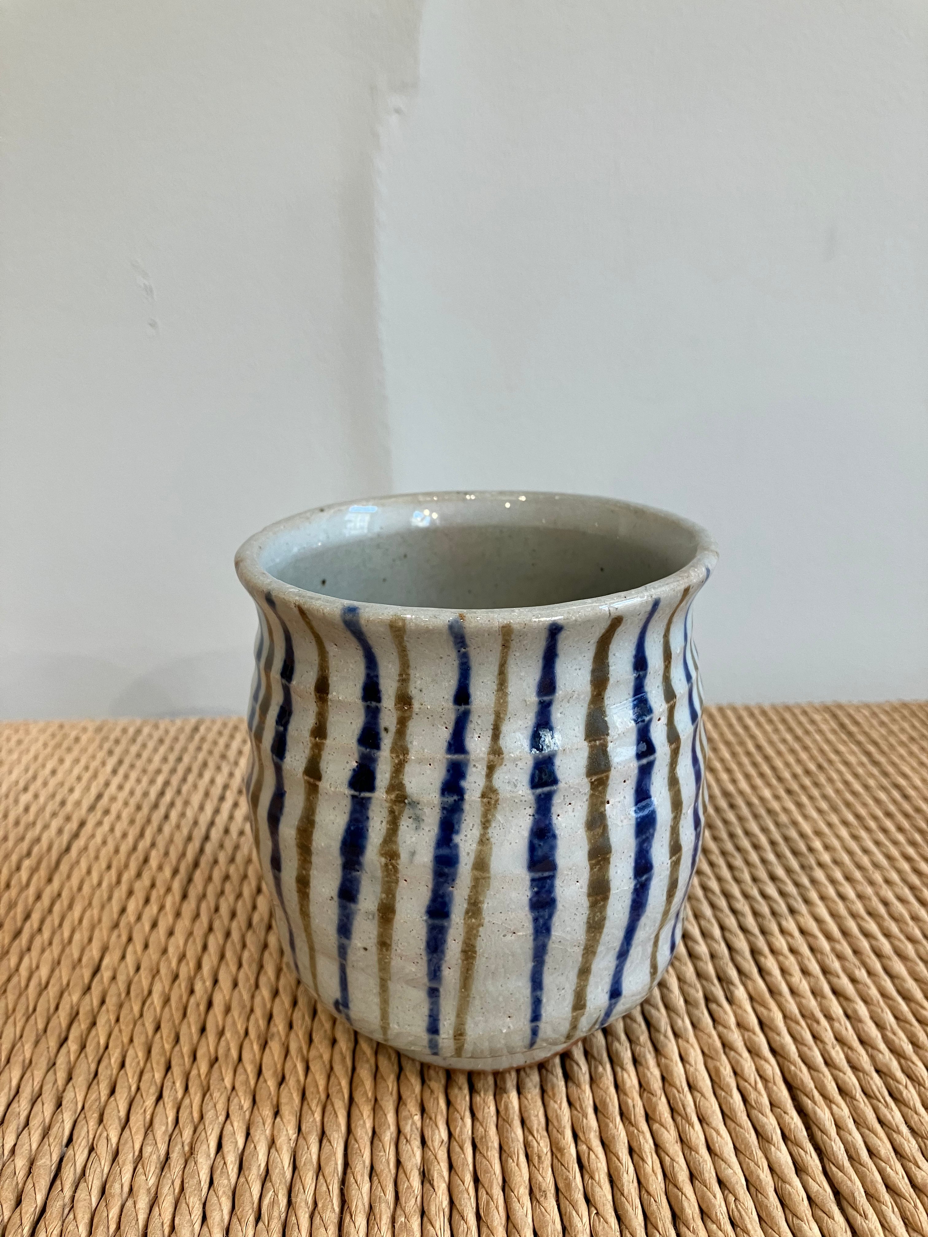 Large striped cup with blue and brown stripes