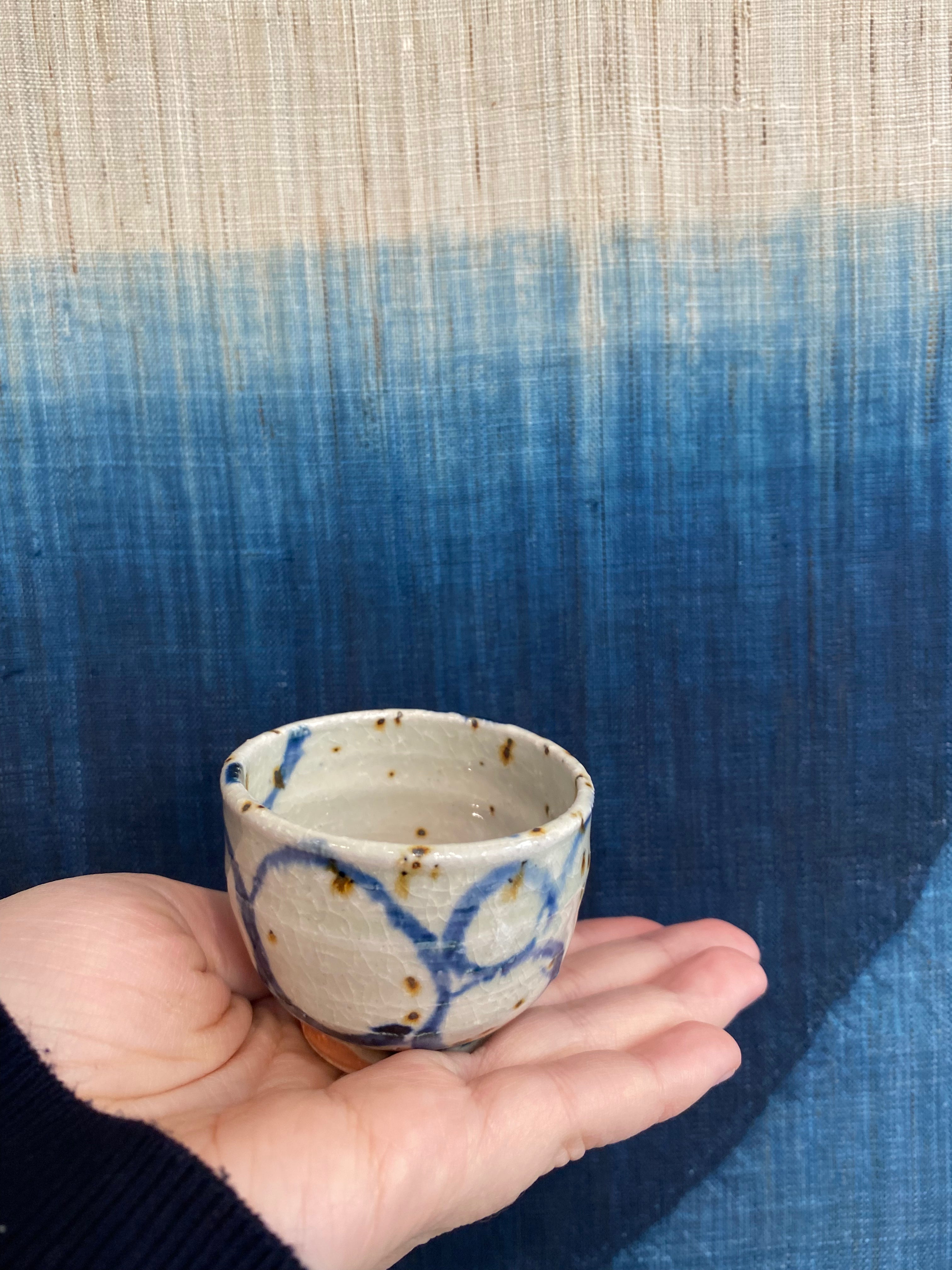 Sake cup with white glaze and blue spiral pattern