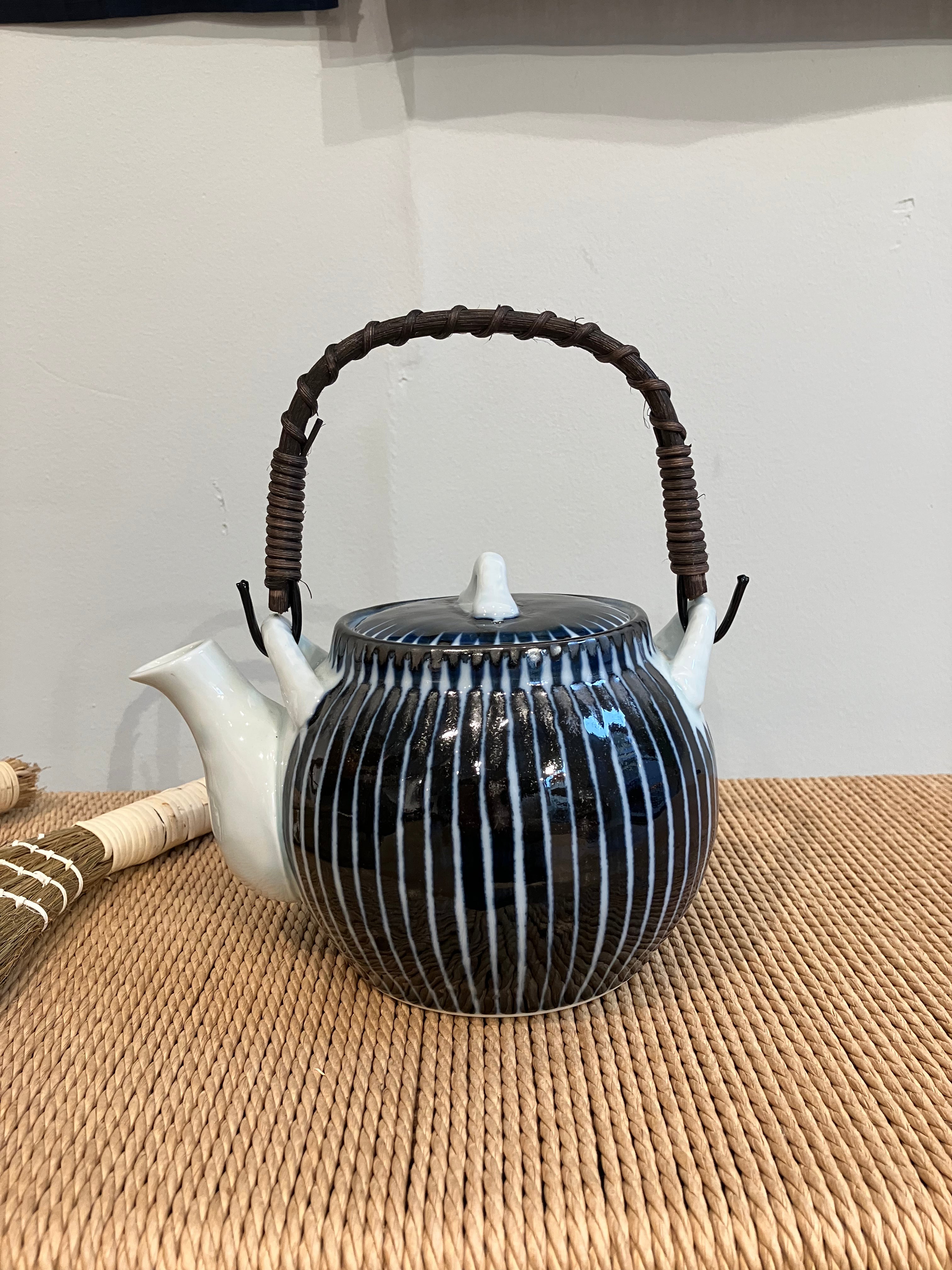 Ceramic teapot with blue stripes and handle