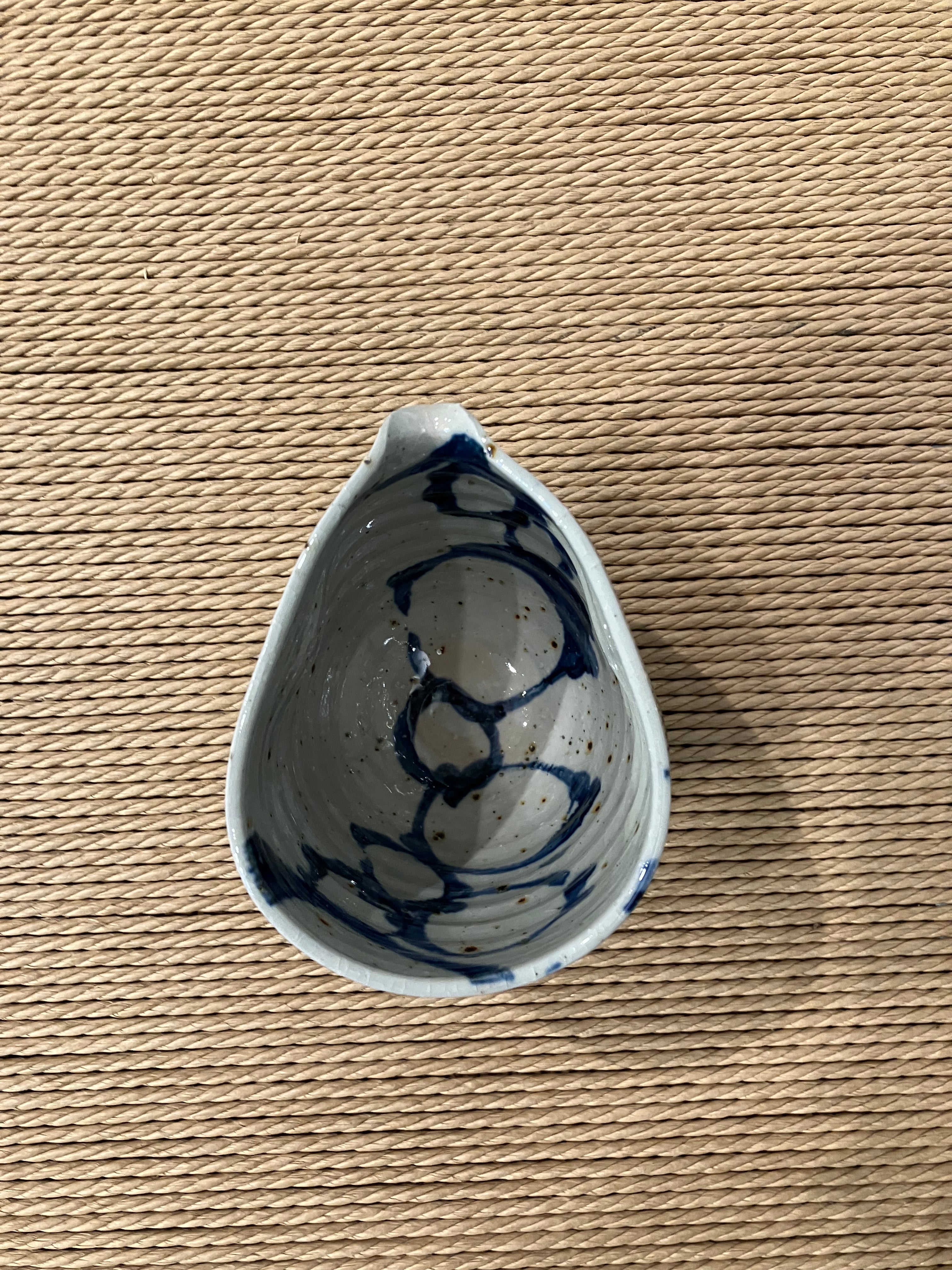 Ceramic jug in an organic shape with a blue pattern
