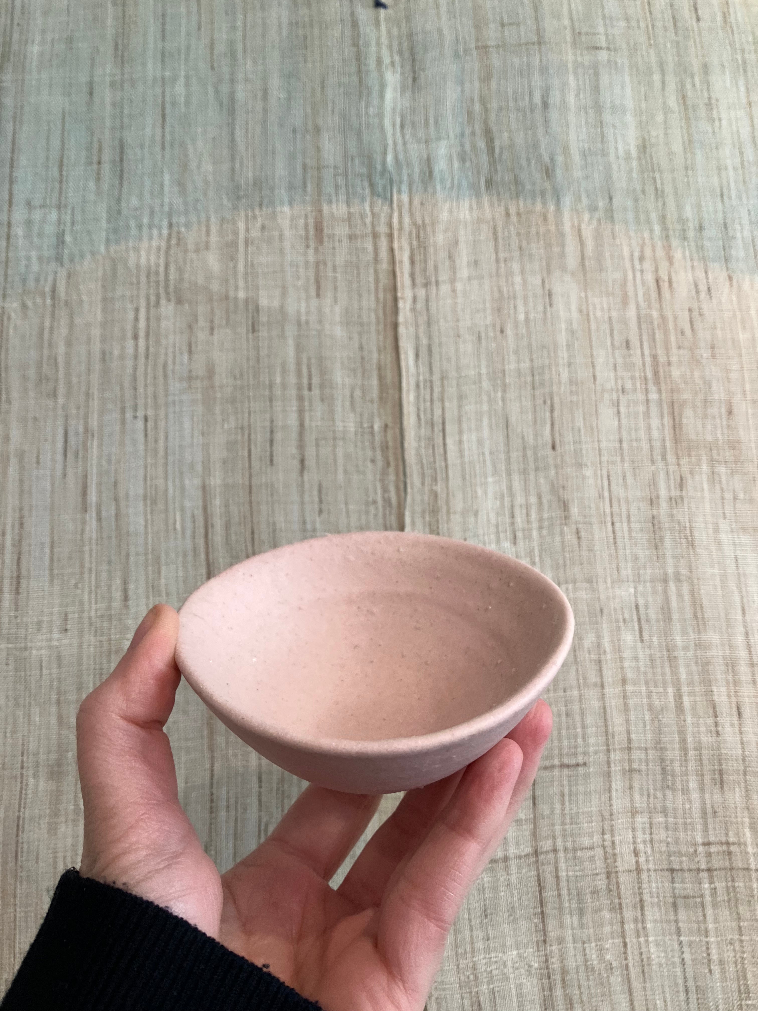 Small bowl with pink glaze and rustic texture