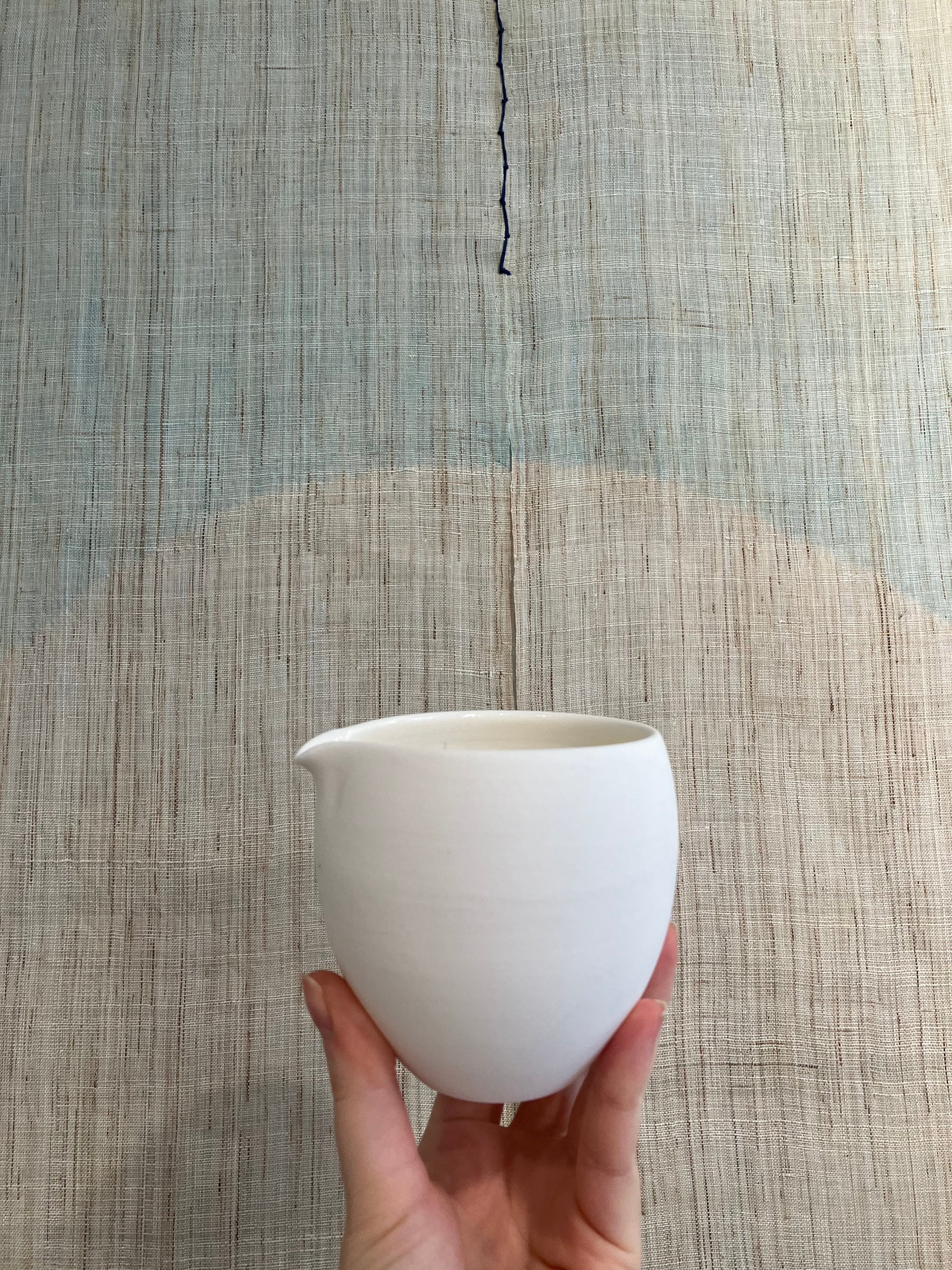 Handmade, white ceramic jug in matt glaze