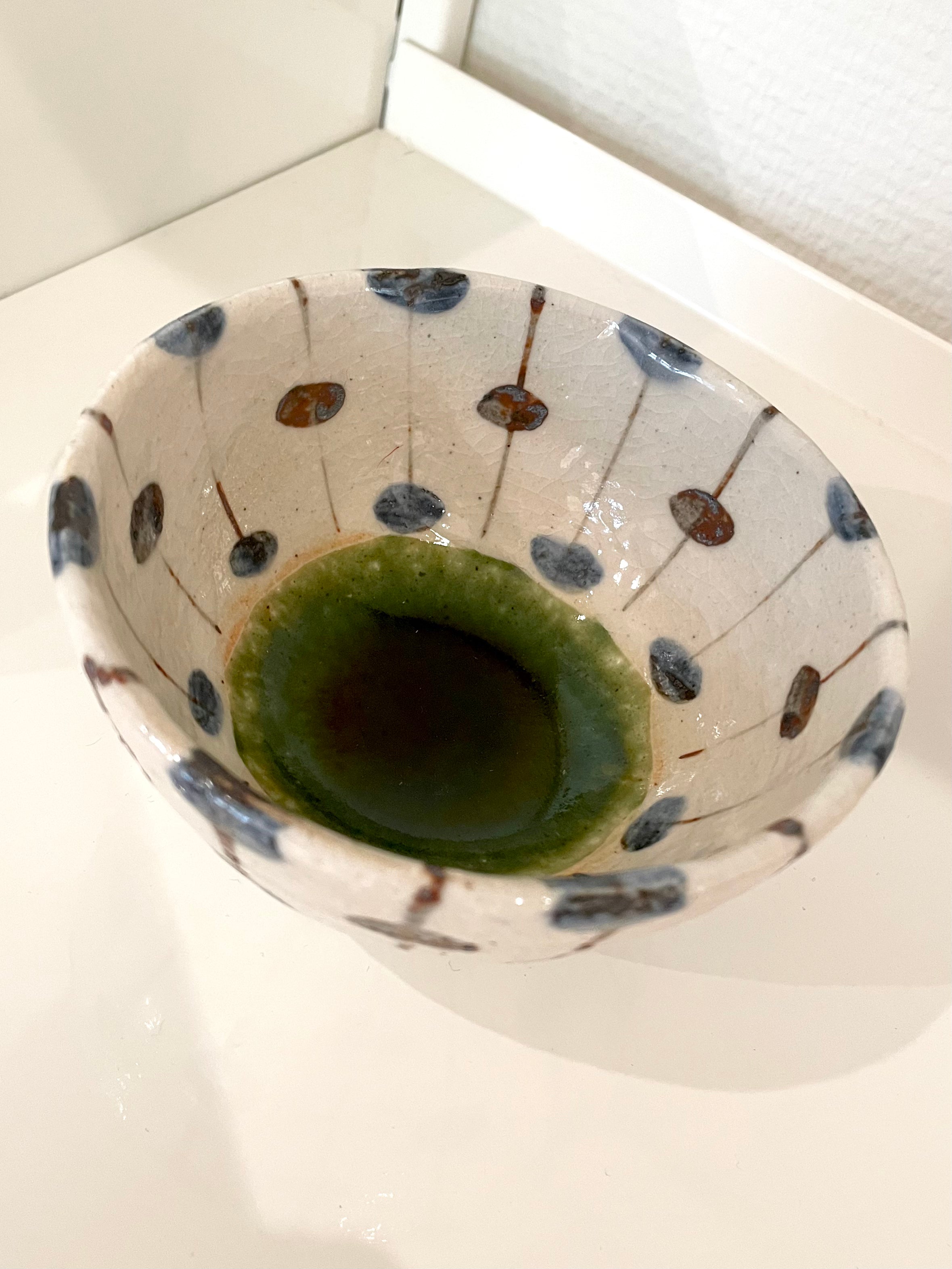 Handmade Japanese bowl with blue and brown dots