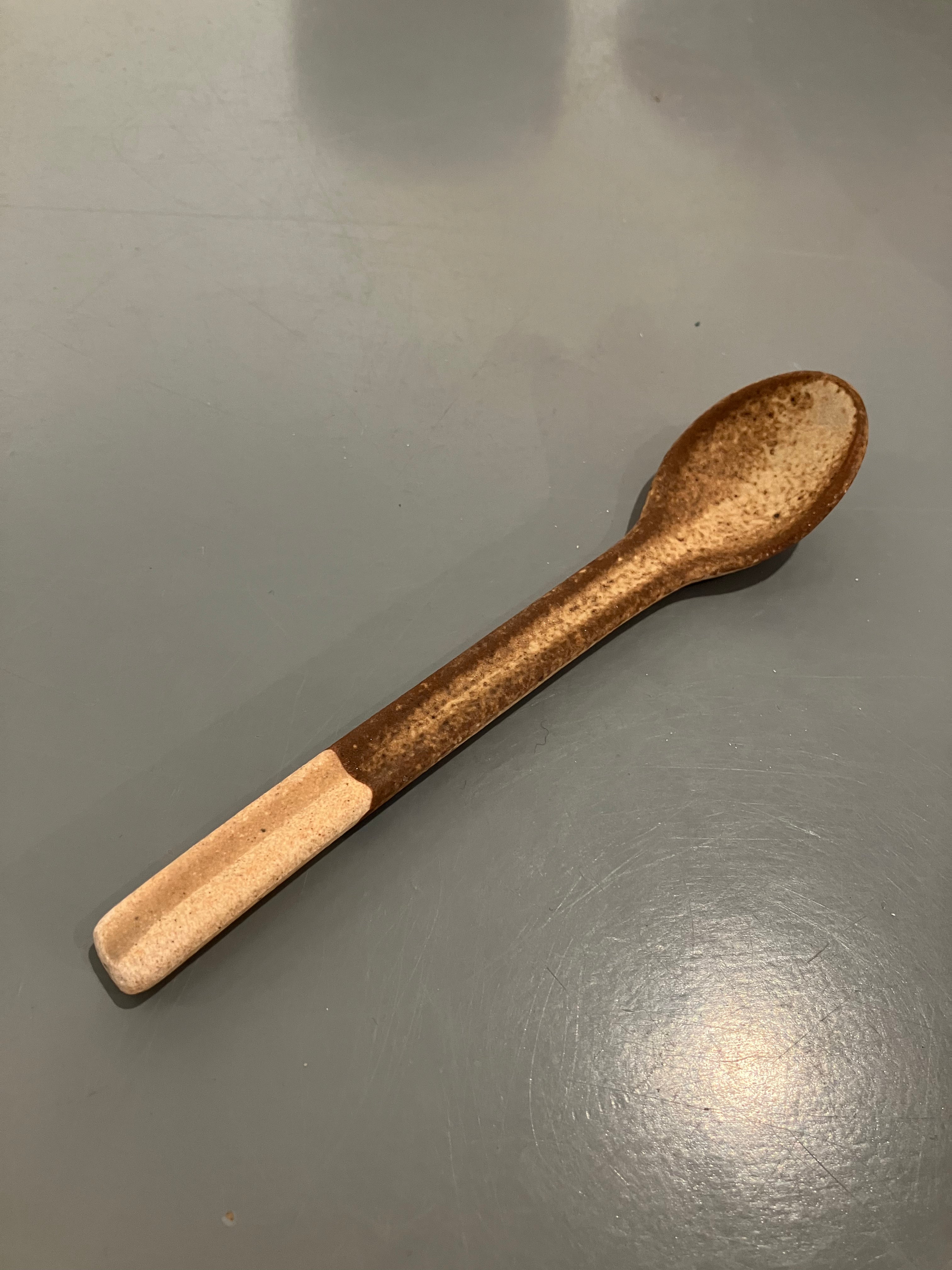 Rustic ceramic spoon with brown glaze