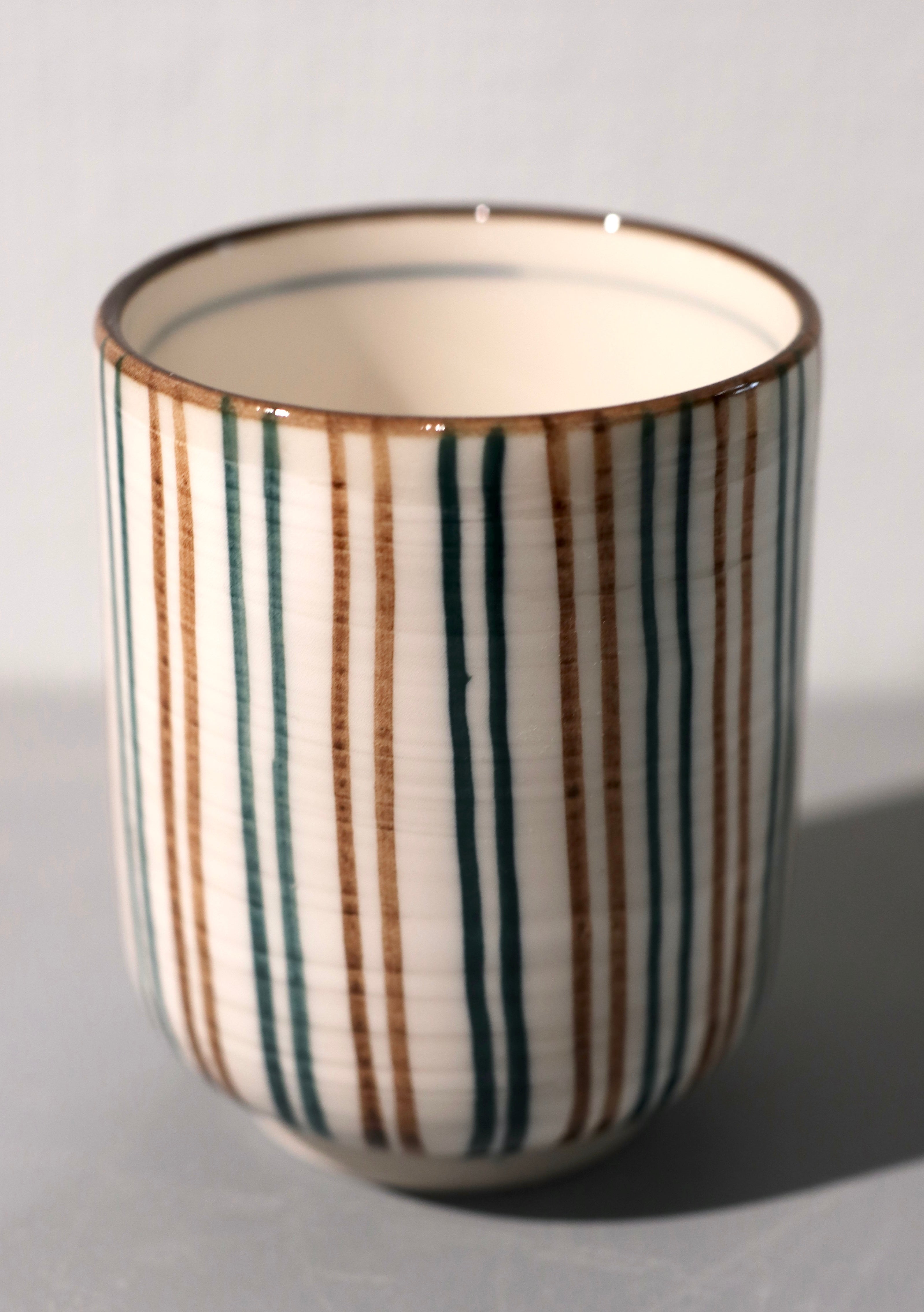 Narrow cup with brown and green stripes