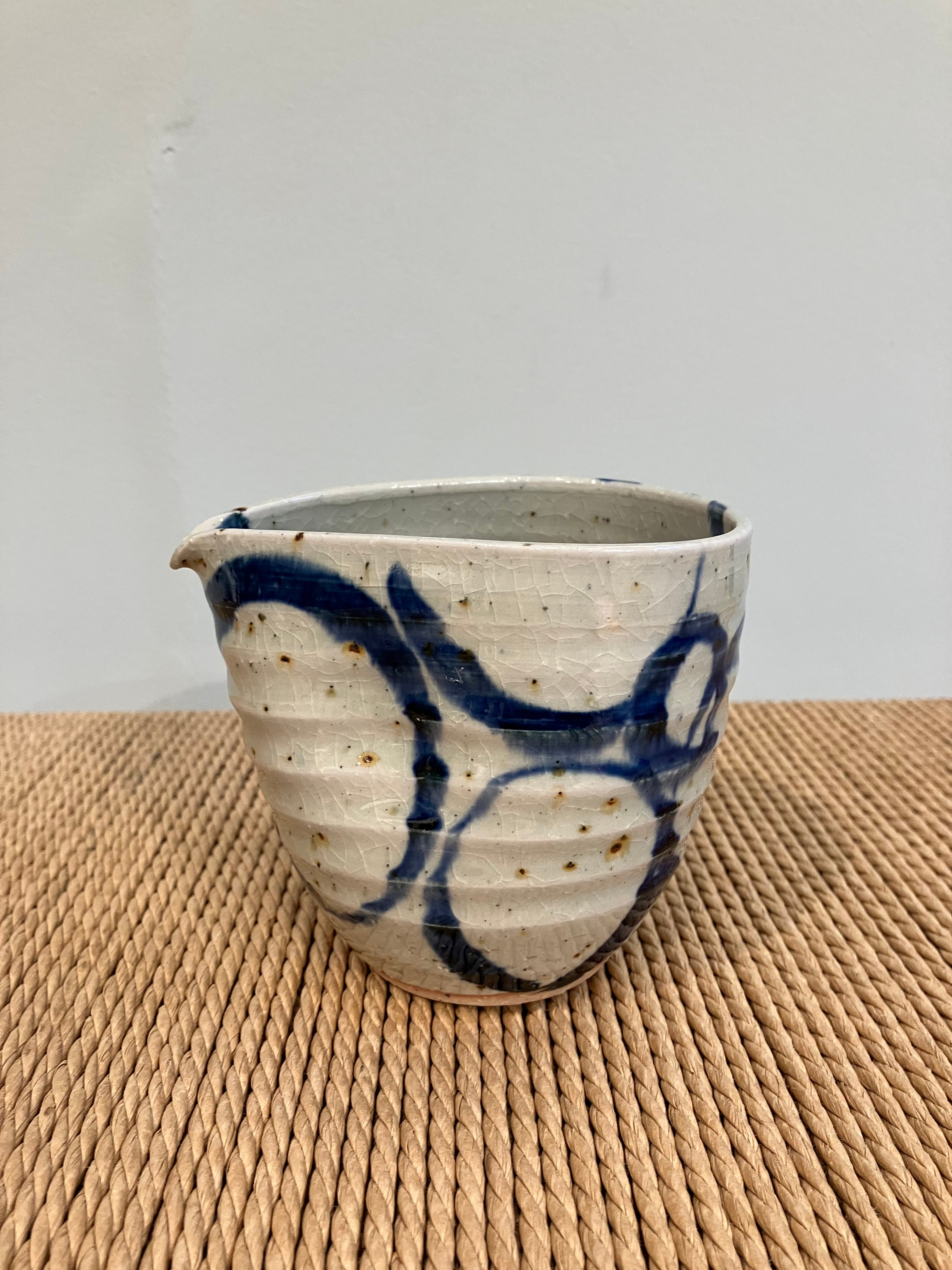 Ceramic jug in an organic shape with a blue pattern