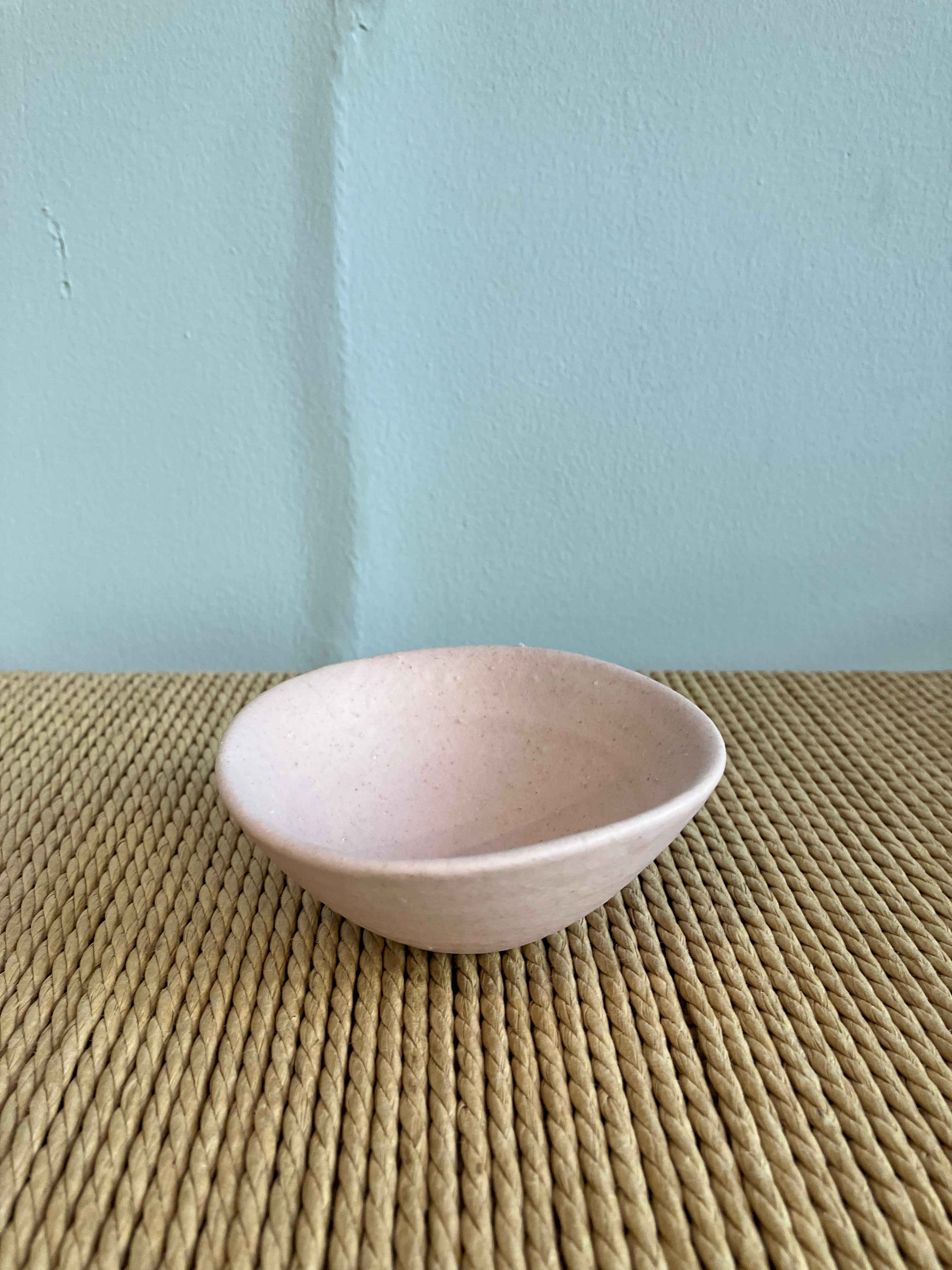 Small bowl with pink glaze and rustic texture