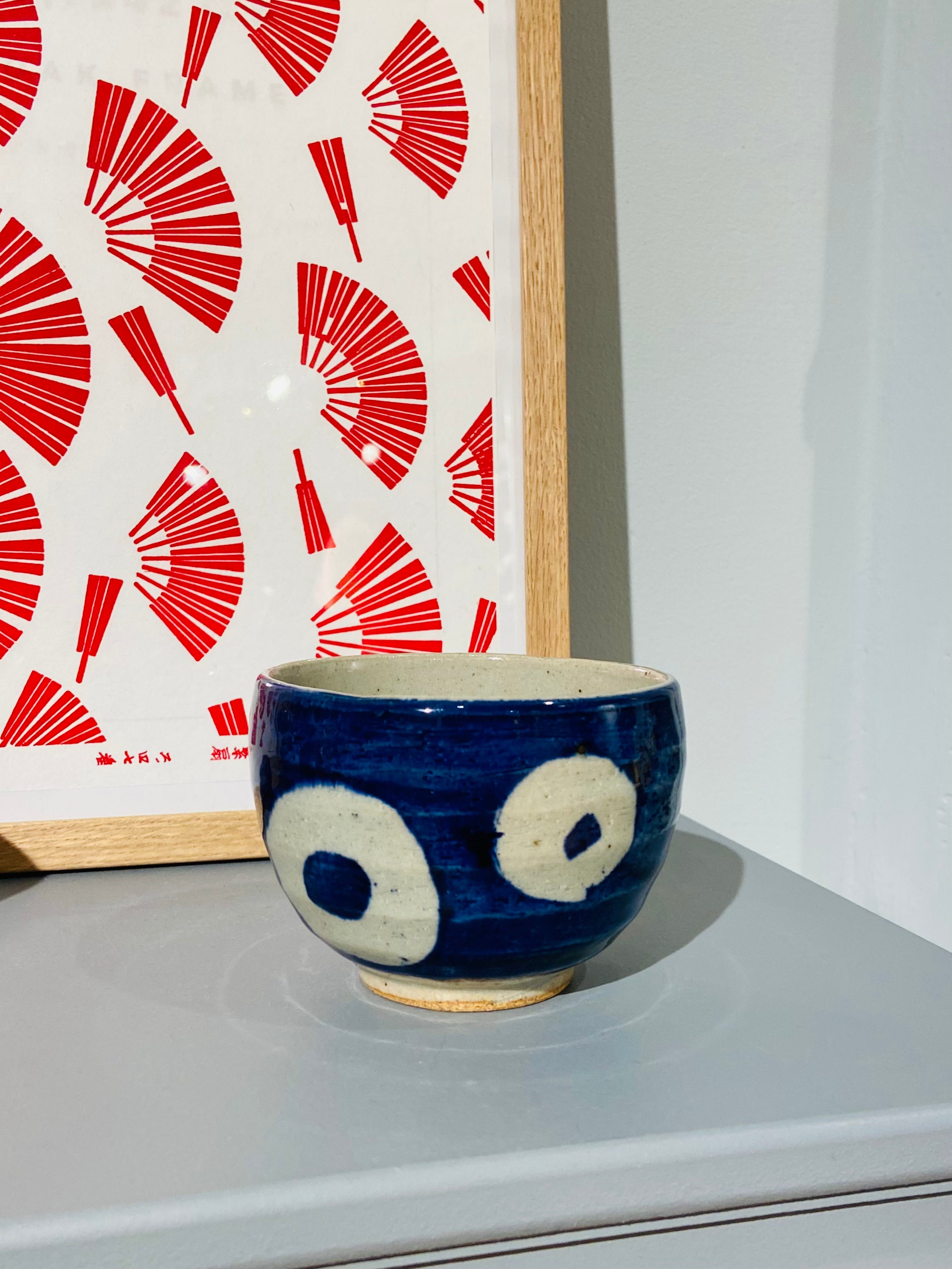Blue ceramic cup with white rings