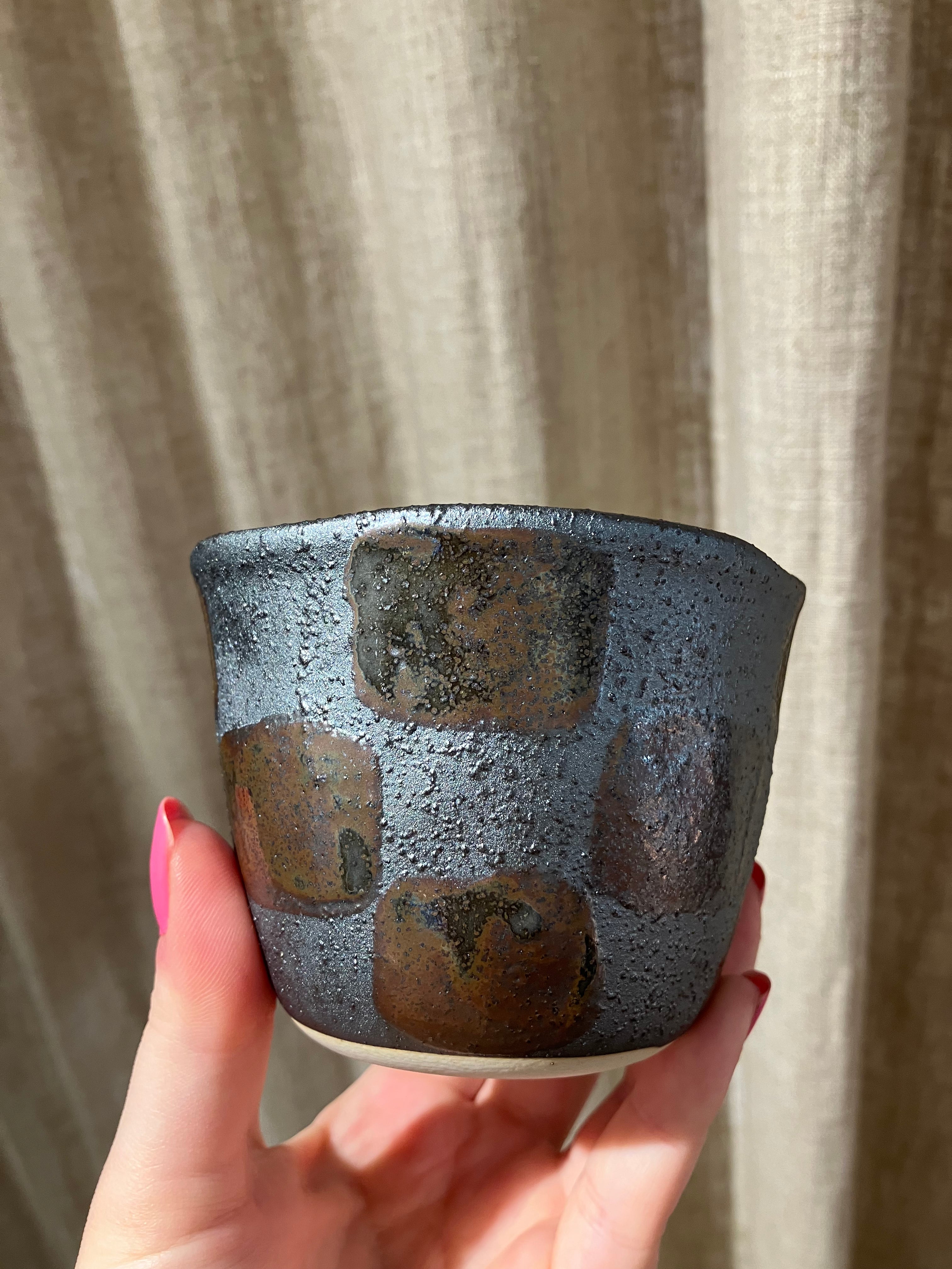 Metallic cup with checkered pattern