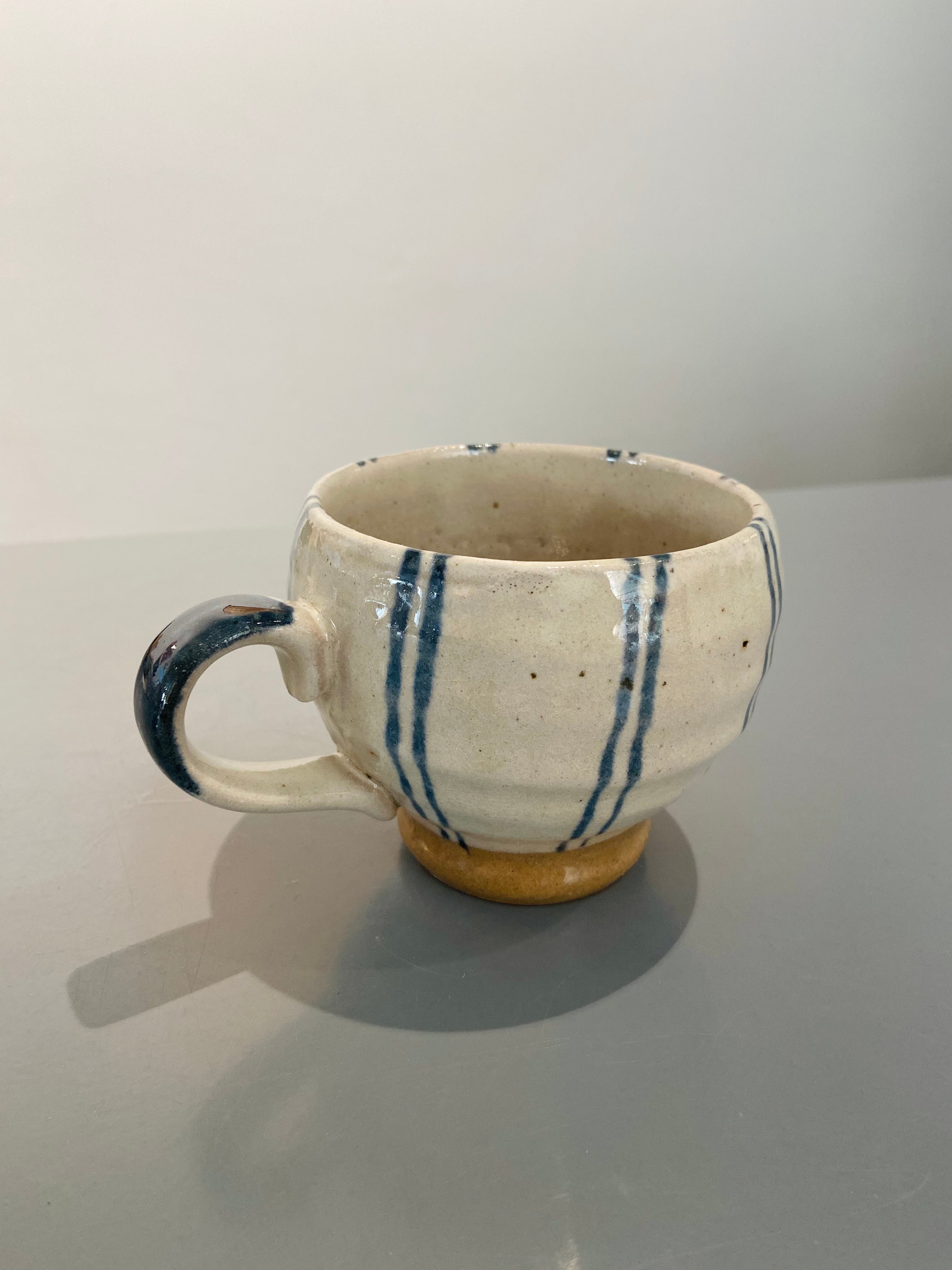 Hand painted ceramic cup with blue stripes