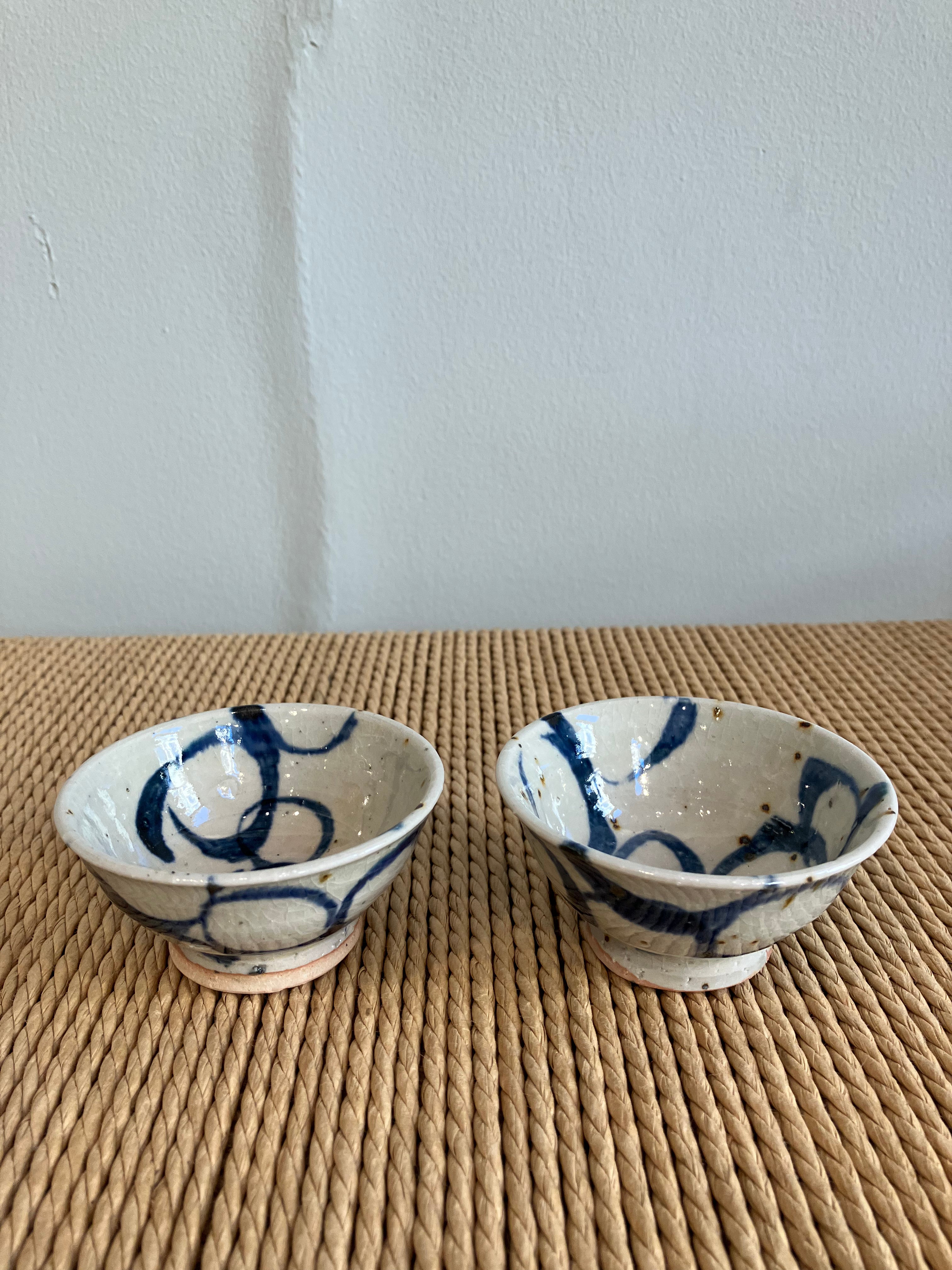Sake cup sand colored glaze and blue spiral pattern