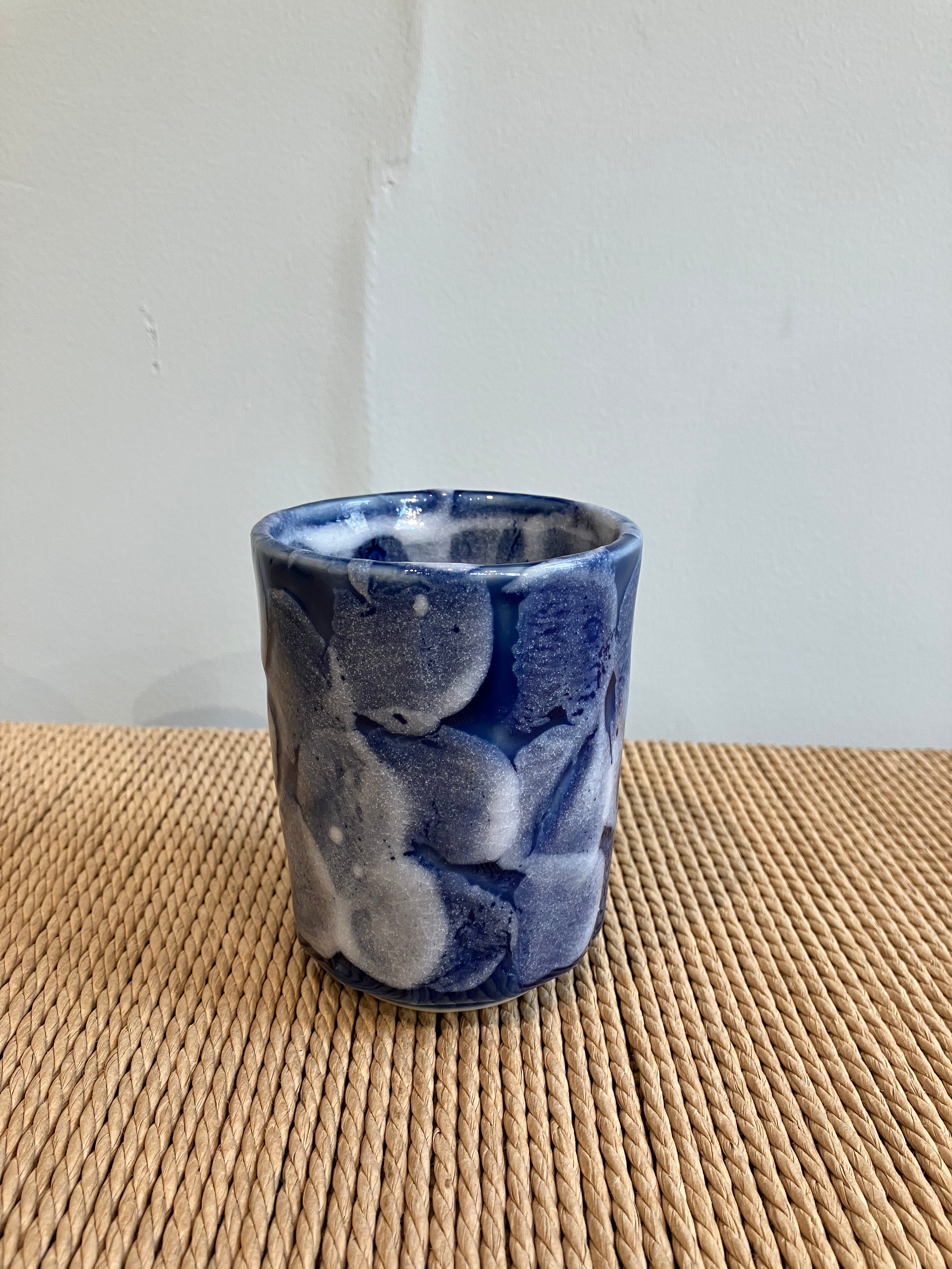 Ceramic cup with blue glaze and white details