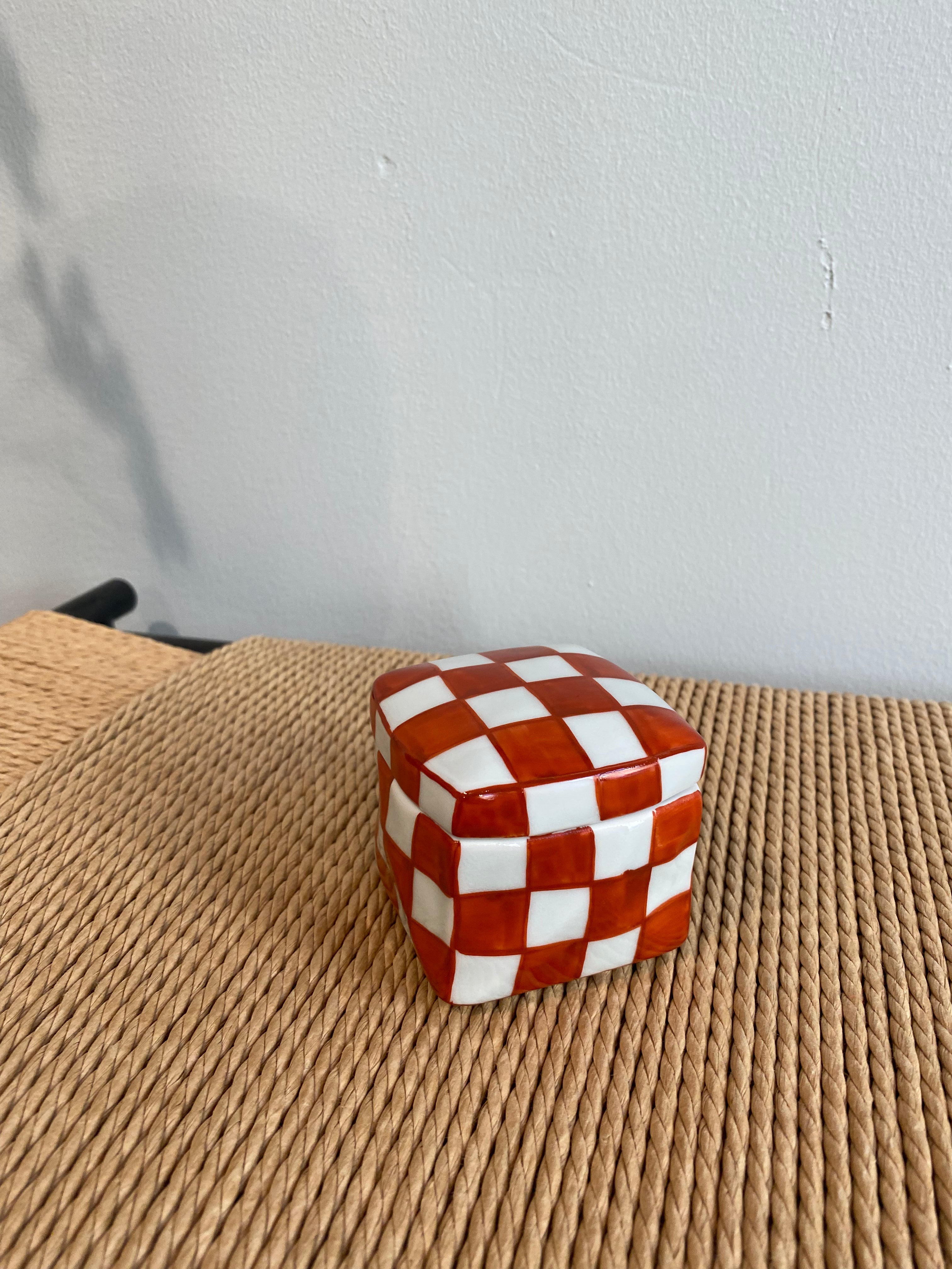 Handmade lidded jar with red/white checkered glaze