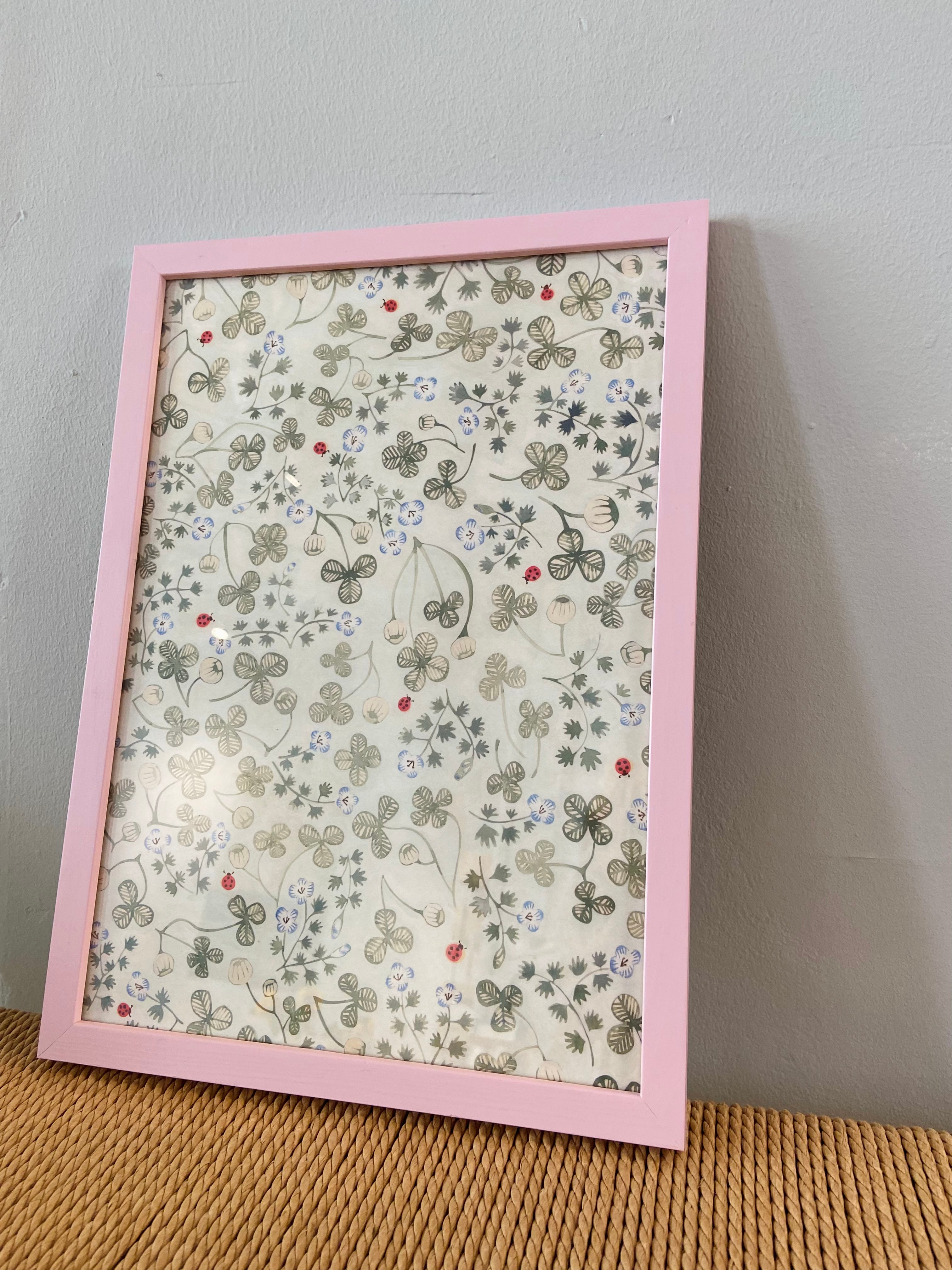 Clover with ladybirds in a pink frame