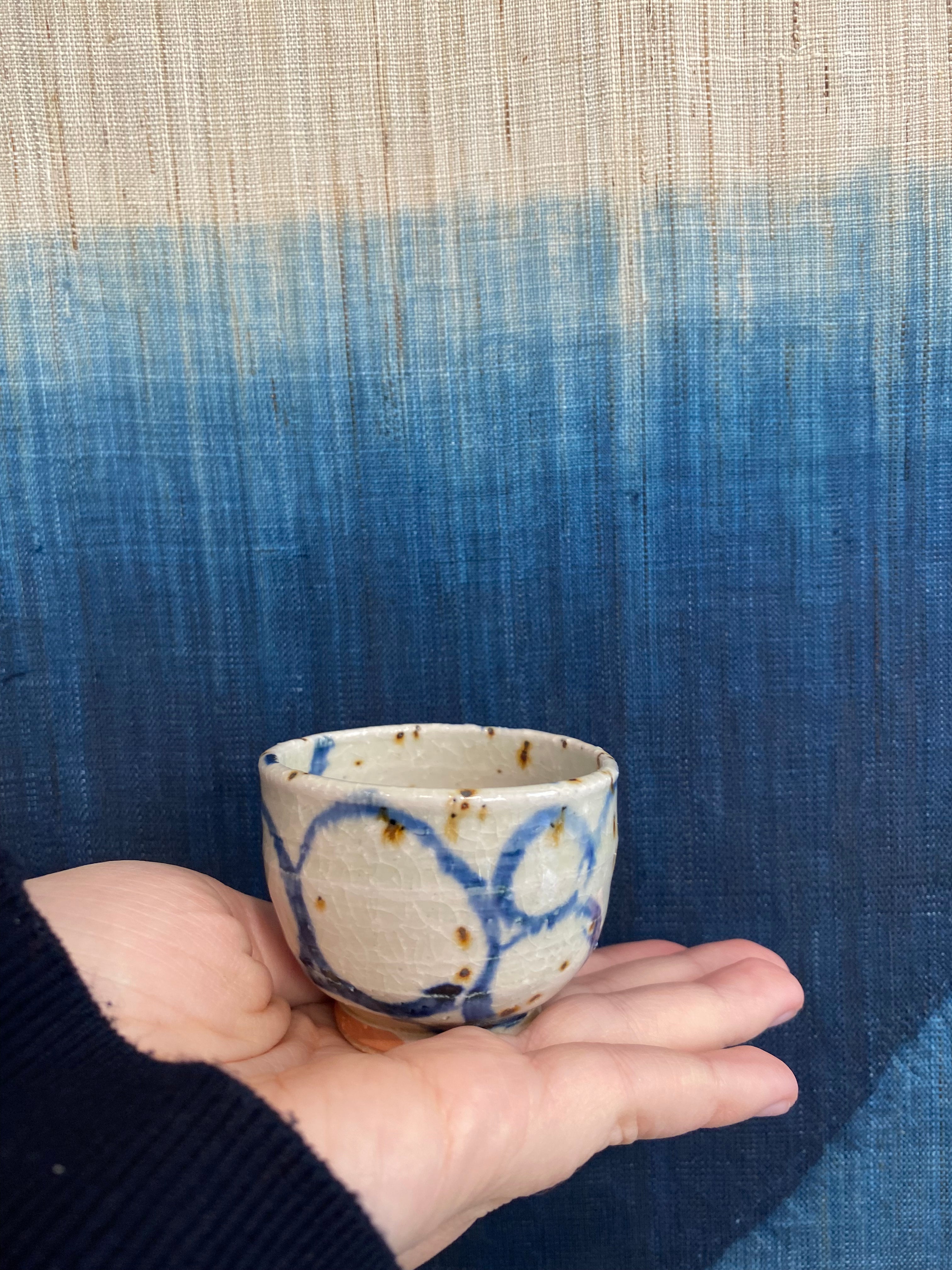 Sake cup with white glaze and blue spiral pattern
