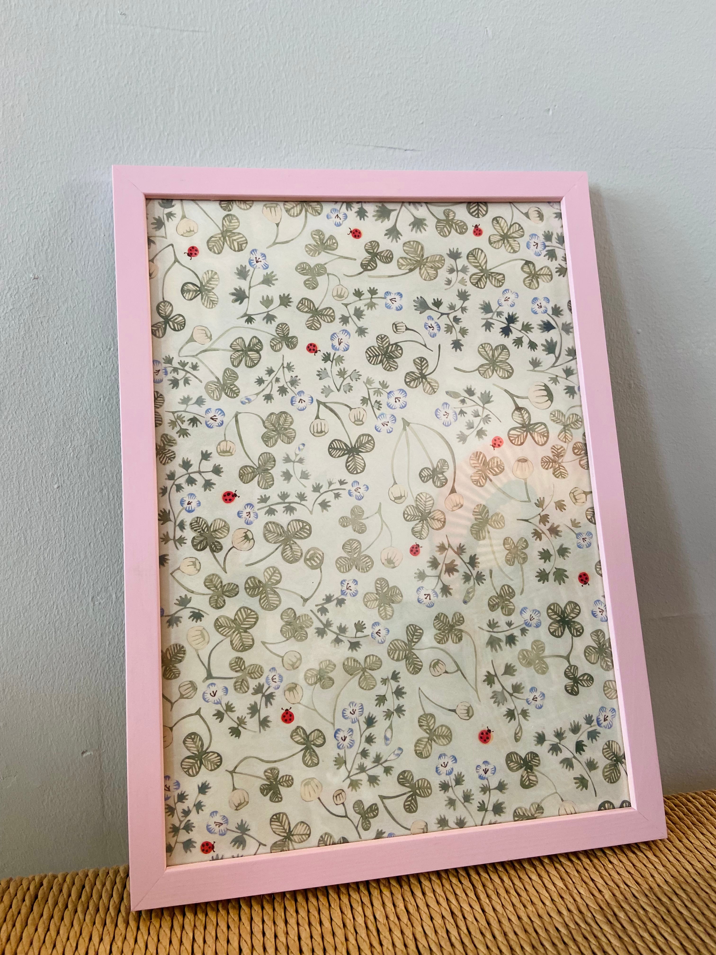 Clover with ladybirds in a pink frame