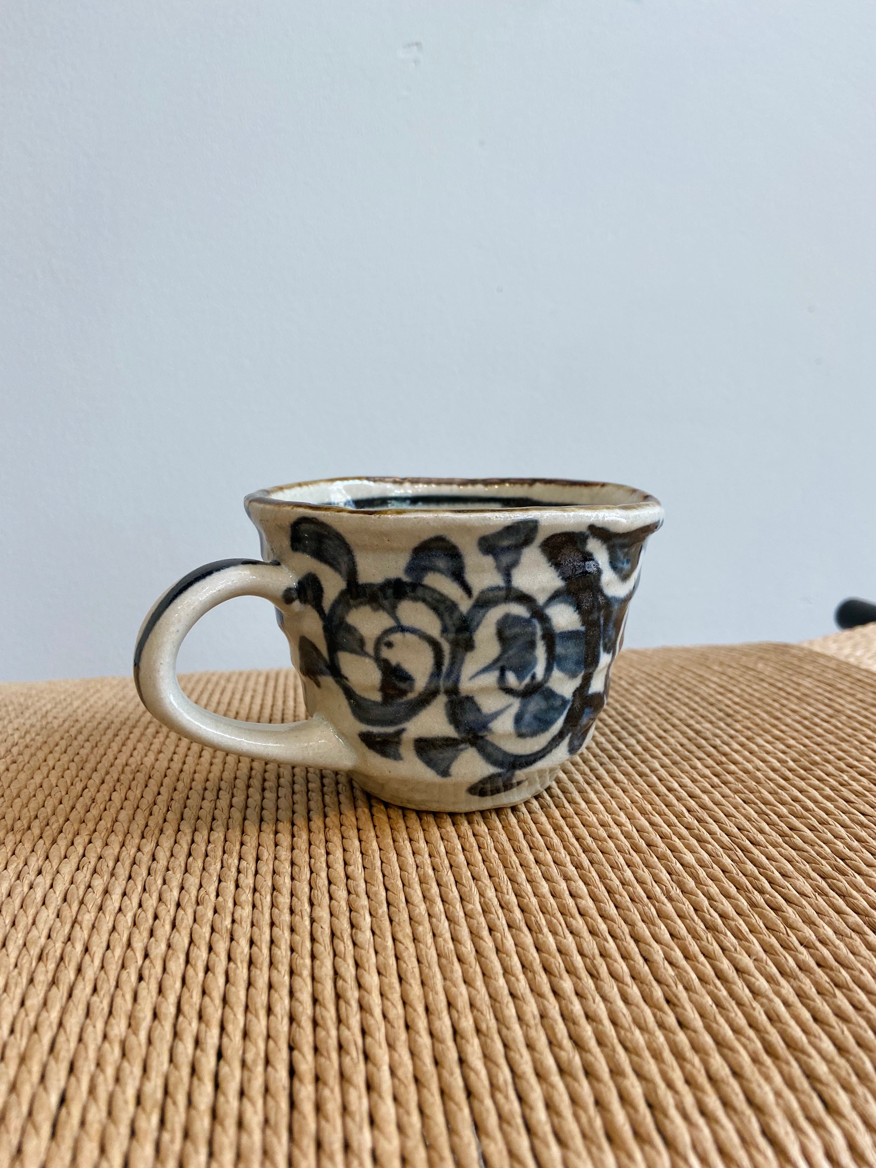 Rustic cup with hand-painted blue pattern