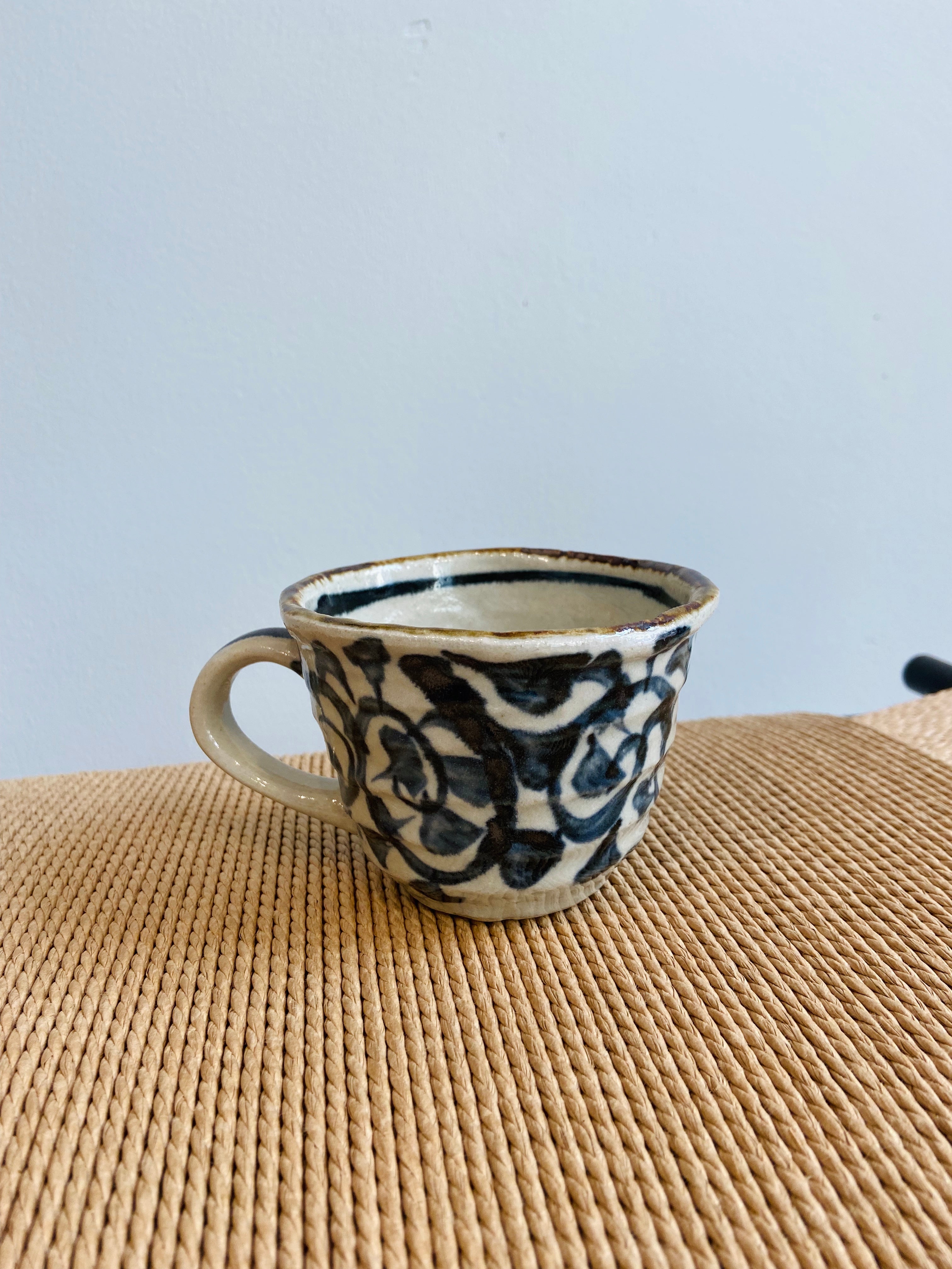 Rustic cup with hand-painted blue pattern