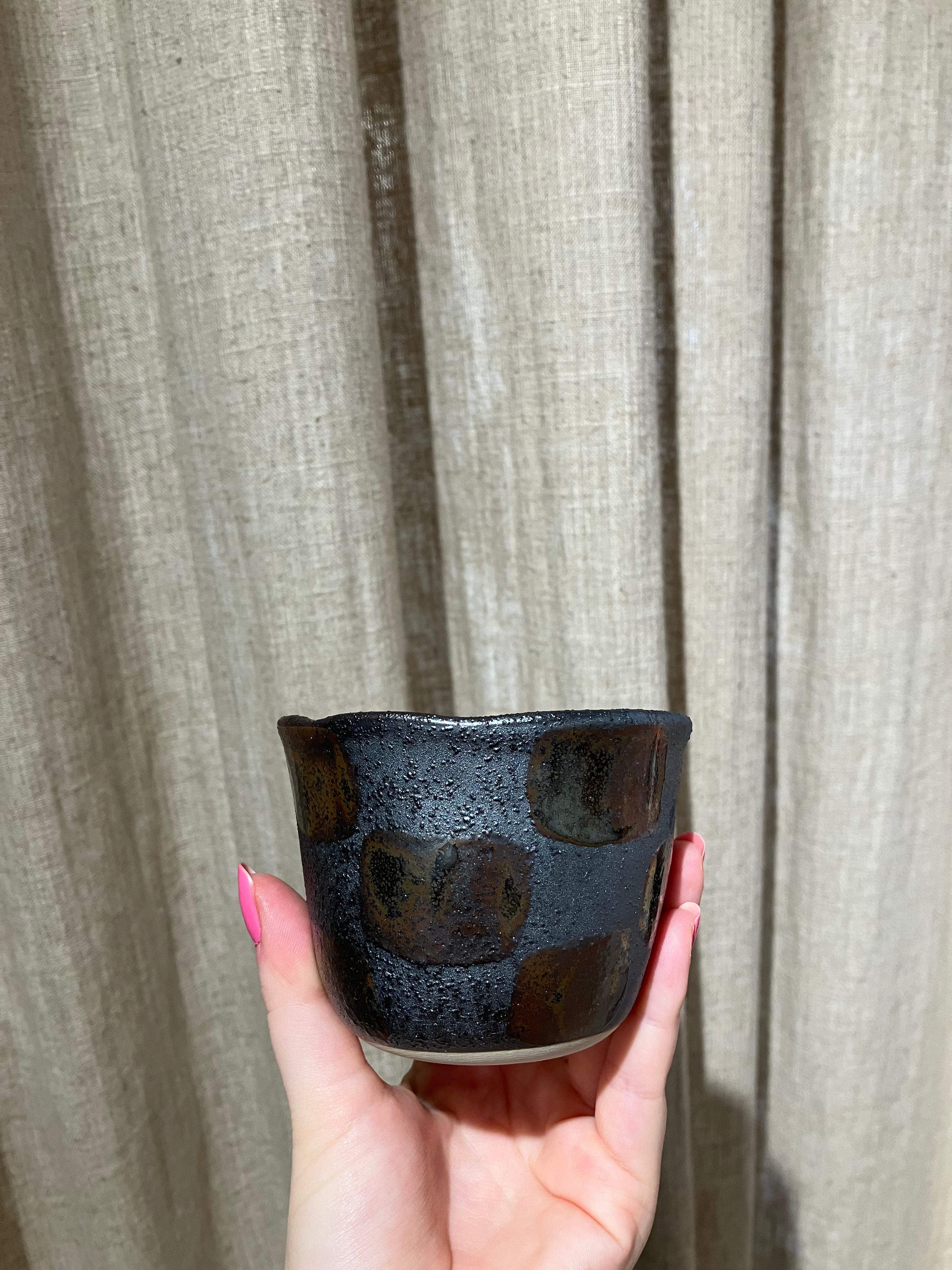 Metallic cup with checkered pattern