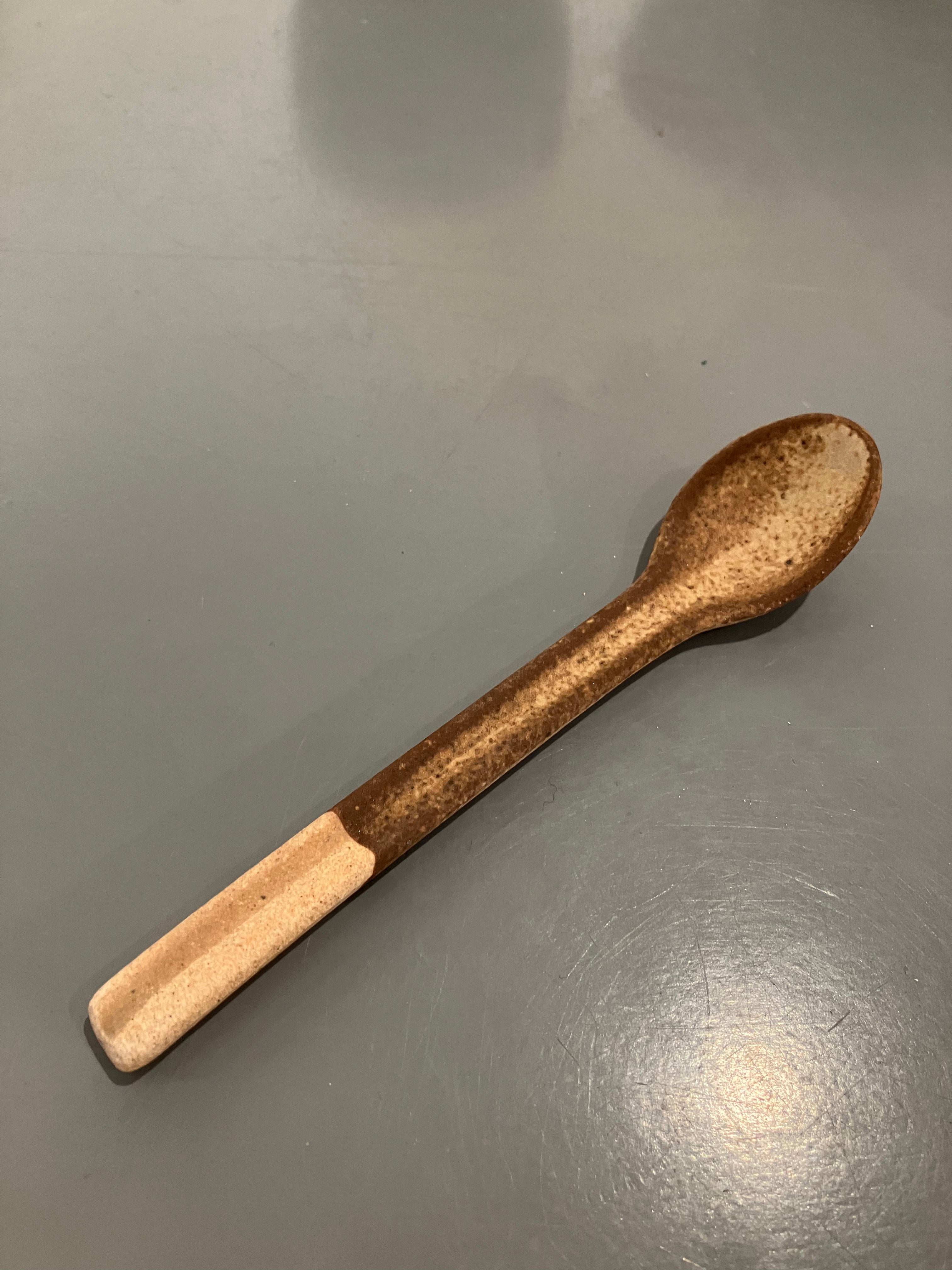 Rustic ceramic spoon with brown glaze