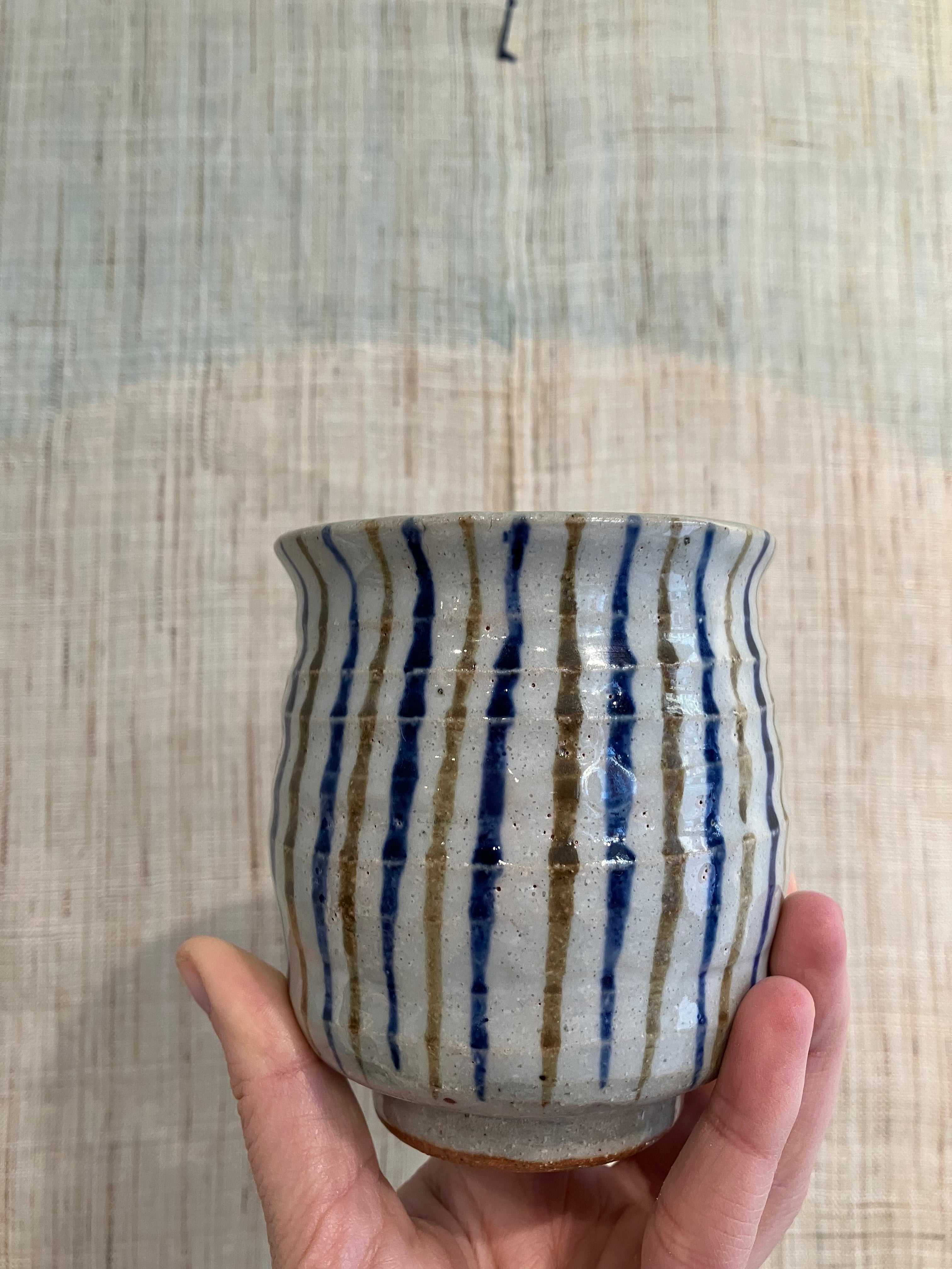Large striped cup with blue and brown stripes