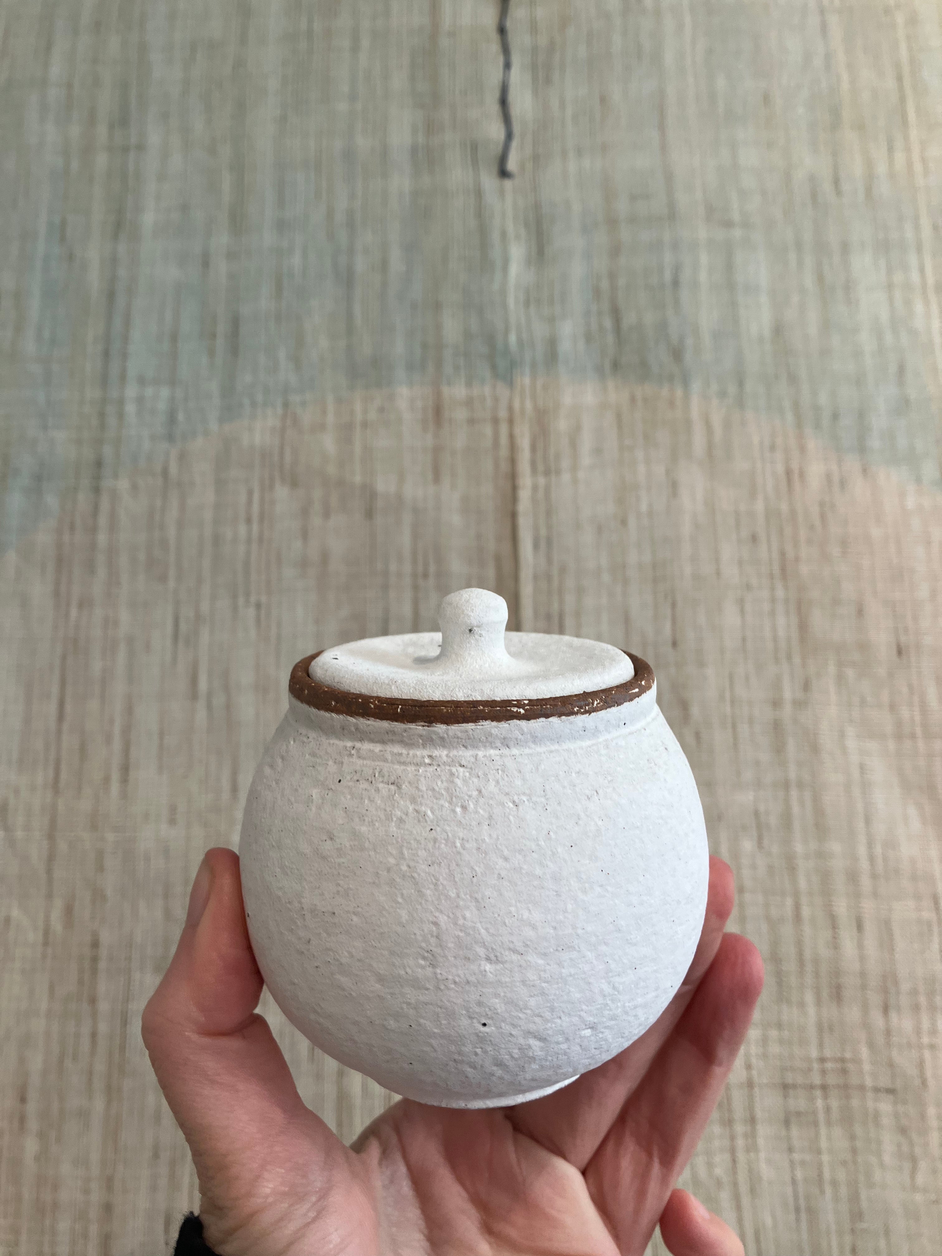 Small white rustic jar with lid