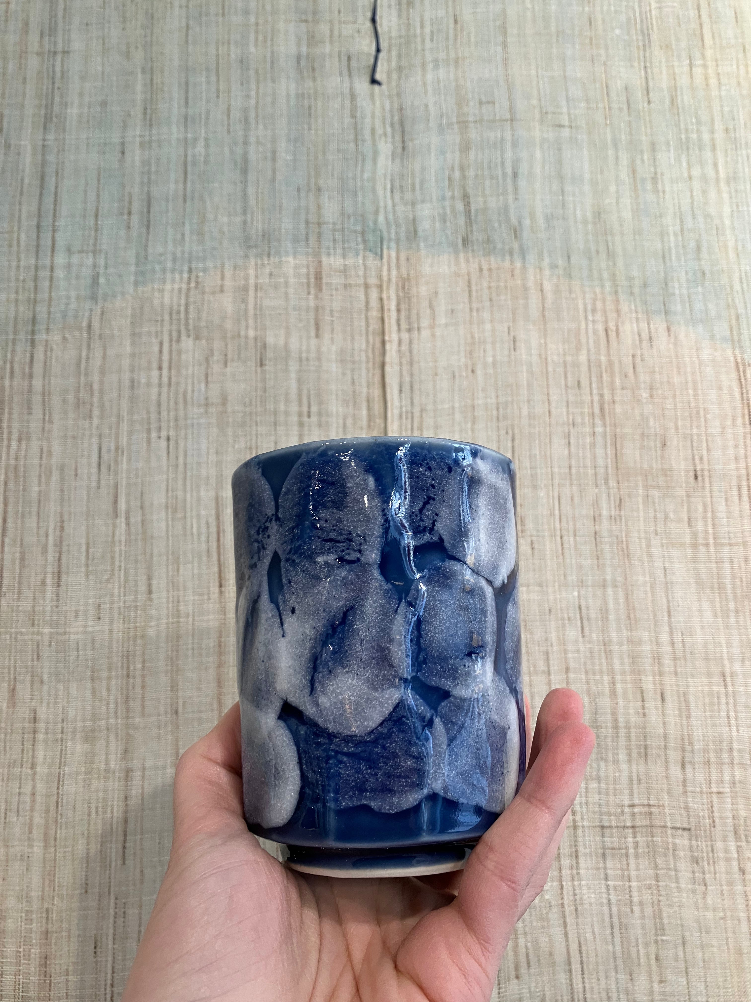 Ceramic cup with blue glaze and white details